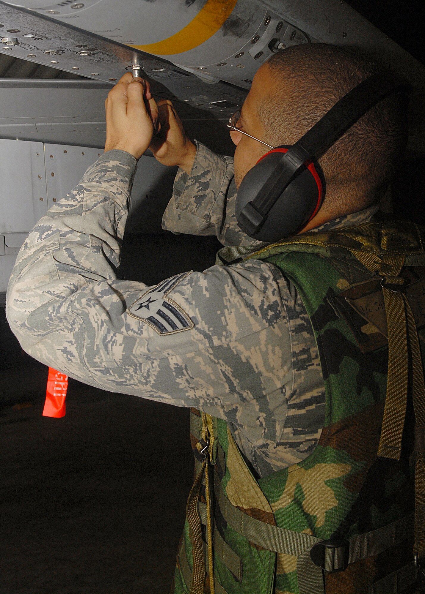 KUNSAN AIR BASE, Republic of Korea -- Senior Airman Jareid Juarbe, 80th Aircraft Maintenance Squadron weapons load crew member, tightens the bolts of an AIM-120 missile to an F-16 here Aug 25. All bolts and screws must be properly secured so that when the AIM-120 missile is released it will function properly. Members of load crews have to precisely and promptly load missiles for flight generation during exercise Beverly Midnight 10-03. (U.S. Air Force photo/Senior Airman Ciara Wymbs)