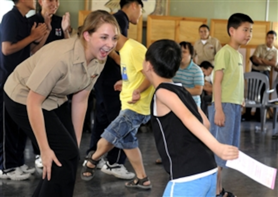 U.S. Navy Seaman Apprentice Jenna Welsh (left), assigned to the U.S. 7th Fleet command ship USS Blue Ridge (LCC 19), dances with Kim Young Min during a community service project at Cheonma Jaehwalwon Rehabilitation Center in Busan, South Korea, on Aug. 24, 2010.  The Blue Ridge is in Busan in support of Commander of 7th Fleet's operations during the annual combined forces exercise Ulchi Freedom Guardian.  