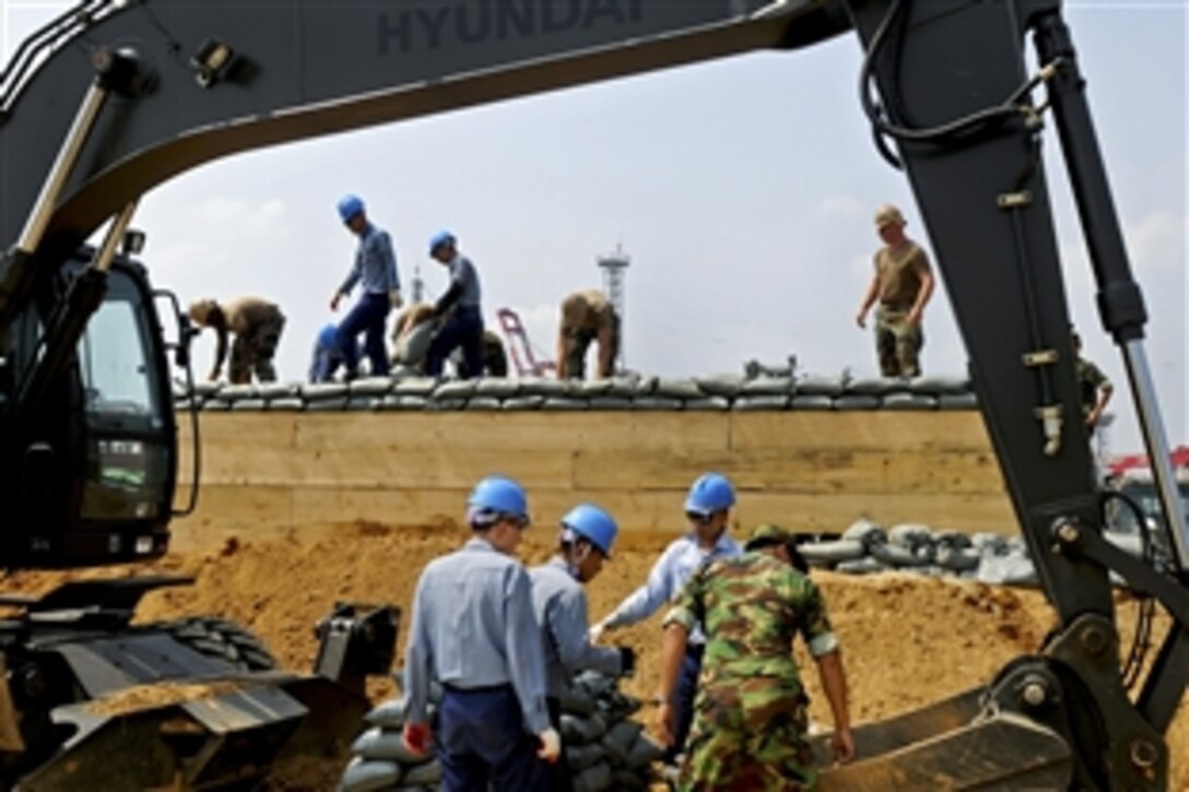 U.S. Navy sailors teach South Korean navy sailors how to build an above-ground heavy timber bunker during a training exercise in Busan, South Korea, Aug. 24, 2010. The U.S. sailors are assigned to Naval Mobile Construction Battalion 11, deployed to Commander, Fleet Activities Chinhae.