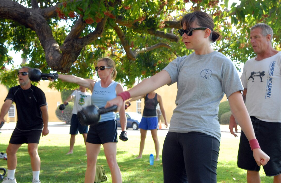 Participants in the kettlebell class outside the depot Fitness Center experience a full body workout, building strength and stability as they execute the techniques, Aug. 25.