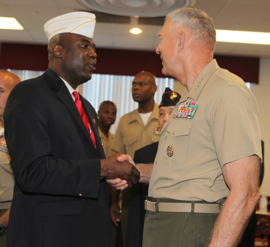 Chief Warrant Officer 4 James T. Averhart Jr. (left), the national president of the Montford Point Marine Association, shakes hands with General James T. Conway (right), commandant of the Marine Corps, during a ceremony honoring African-American Marines who served in the Marine Corps in the 1940s aboard Montford Point Camp, now Camp Johnson, Aug. 26.  Senate resolution 587 formally recognizes contributions made by African-Americans to God, Corps and country.