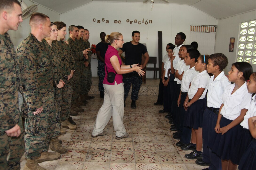 Kari L. Williams, native of Orlando, Fla., and public affairs representative for Give a Kid a Backpack, tells Westfalia School students and Marines to count to ten in Spanish during a visit to the school in Limon, Costa Rica, Aug. 26, 2010. Marines worked with non-government organization Give a Kid a Backpack in passing out school-supplied backpacks and toys to children. Service members and civilians are deployed in support of CP10, providing humanitarian assistance and disaster relief to the Caribbean, Central and South America.