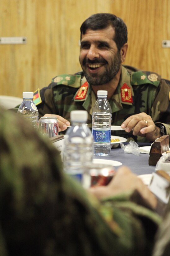Brig. Gen. Malouk, 215th Corps commander, socializes with fellow coalition forces leadership during an iftar celebration held at Camp Leatherneck, Afghanistan Aug. 26.  Iftar, an evening meal between friends and family, ends the fast held from dawn to sunset every day during the holy Islamic month of Ramadan.::r::::n::