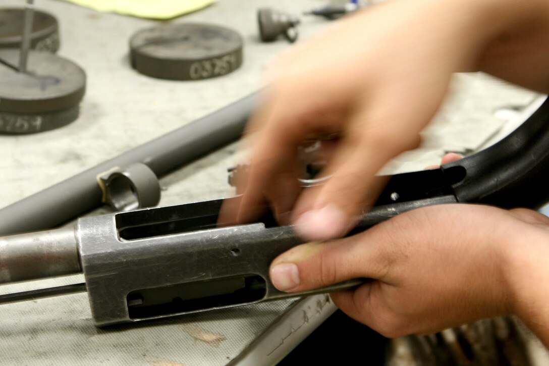 An armorer with Infantry Weapons Repair Facility, 2nd Maintenance Battalion, Combat Logistics Regiment 25, conducts annual repairs on a weapon in his section.  Each section in the shop handles different types of weapons systems and repairs. (U.S. Marine Corps photo by Lance Cpl. Katherine M. Solano)