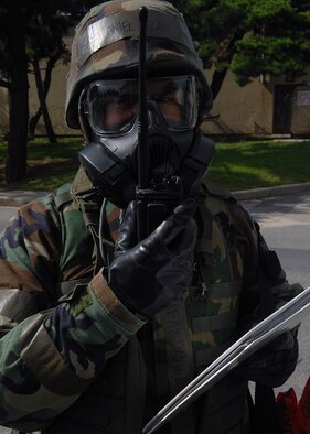 KUNSAN AIR BASE, Republic of Korea -- An 8th Fighter Wing post-attack reconnaissance team member reports findings to his unit control center during alarm black here Aug. 26 during exercise Beverly Midnight 10-03. The exercise introduced scenarios throughout the Wing including non-combatant evacuation operations, medical response, base defense, aircraft weapons loading and aircraft generation. (U.S. Air Force photo/Senior Airman Ciara Wymbs) 