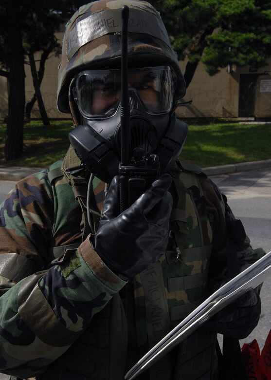 KUNSAN AIR BASE, Republic of Korea -- An 8th Fighter Wing post-attack reconnaissance team member reports findings to his unit control center during alarm black here Aug. 26 during exercise Beverly Midnight 10-03. The exercise introduced scenarios throughout the Wing including non-combatant evacuation operations, medical response, base defense, aircraft weapons loading and aircraft generation. (U.S. Air Force photo/Senior Airman Ciara Wymbs) 