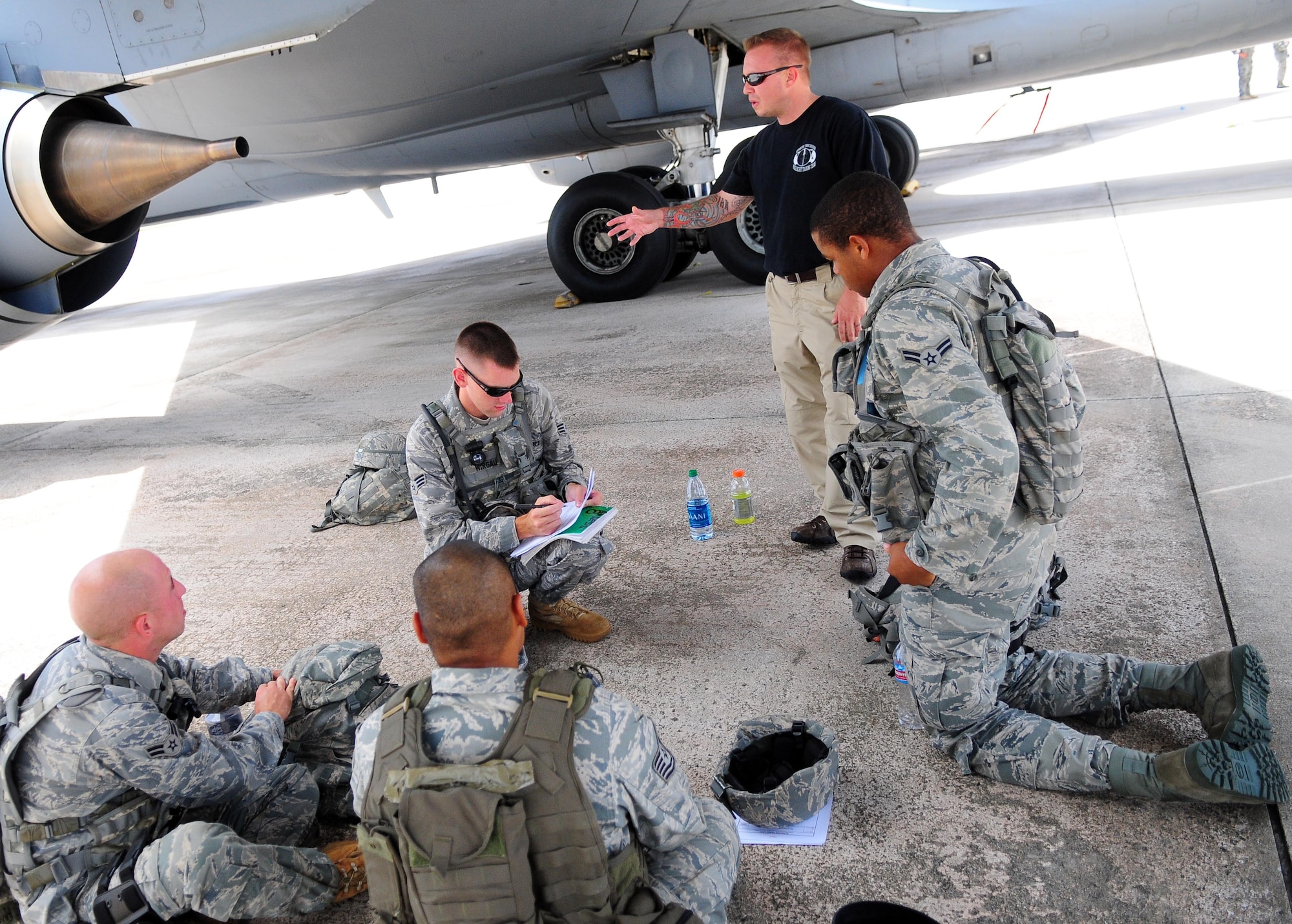 ANDERSEN AIR FORCE BASE, Guam ? Airmen from the 736th Security Forces Squadron receive Fly-Away Training from a Pacific Air Forces instructor on the flightline, Aug. 6. The program enables Airmen to utilize communication as a tool to avoid conflict. (U.S. Air Force photo by Airman Julian North)
