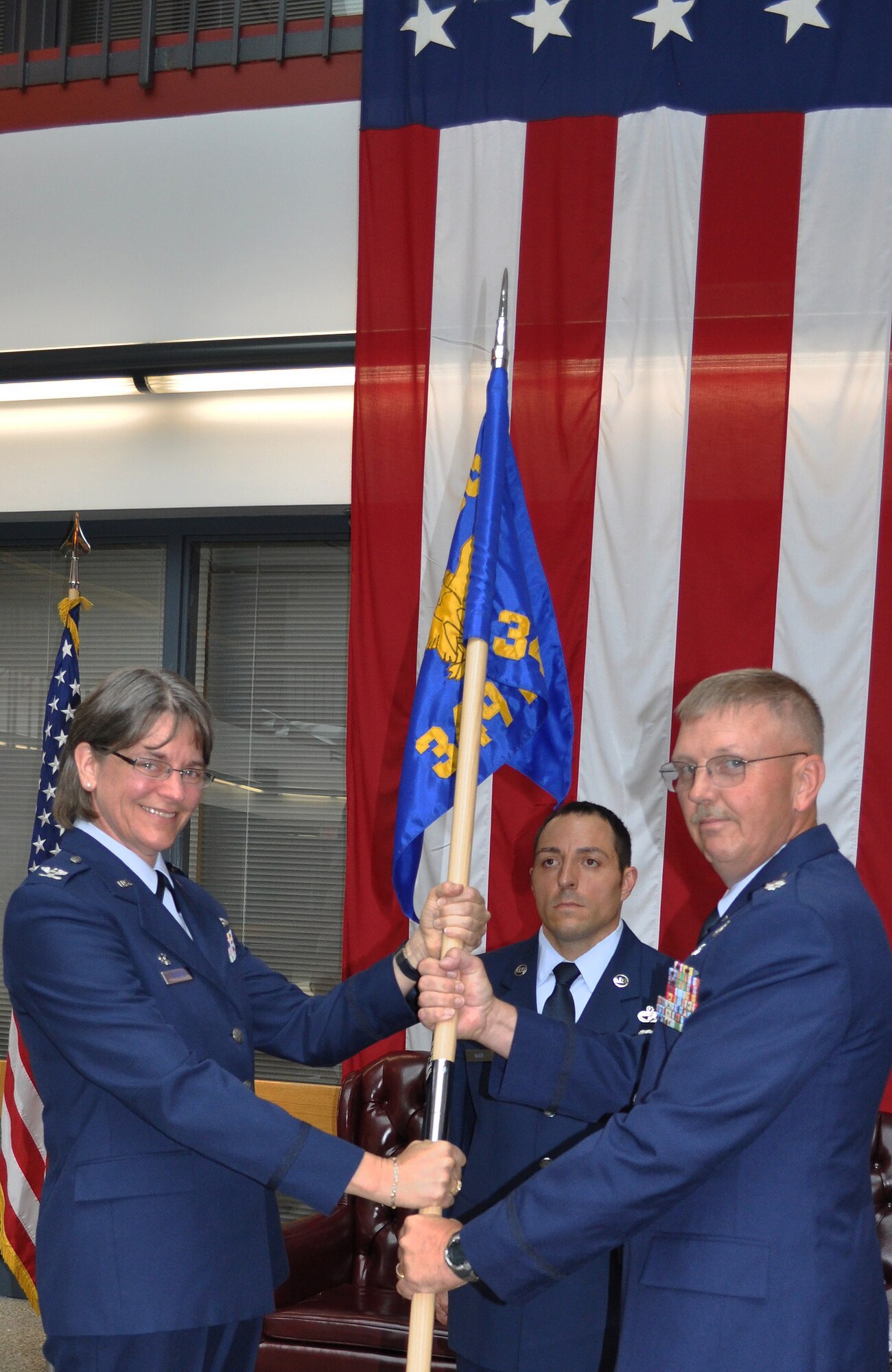 TRAVIS AIR FORCE BASE, Calif. -- With the passing of the squadron flag, Lt. Col. Neal Landeen accepted command of the 349th Mission Support Squadron from Col. Nancy Brooks, 349th Mission Support Group commander, on Aug. 22. Relinquishing command was Lt. Col. Lynn Marshall, who accepted the position as the wing Inspector General. A prior U. S. Marine, Colonel Landeen is a native of, and still lives in, Sioux Falls, S.D. He comes to Travis Air Force Base from the Air Force Reserve's 934th Airlift Wing, Minneapolis-St. Paul International Airport Air Reserve Station, Minn., where he was commander of the Services Squadron. His sons are carrying on the military tradition, with one in U.S. Army OCS and another at the U.S. Naval Academy. His wife, Laurie, a doctor, is also prior Air Force. In his civilian life, Colonel Landeen says he is "Mr. Mom." (U.S. Air Force photo/Senior Master Sgt. Ellen L. Hatfield)
