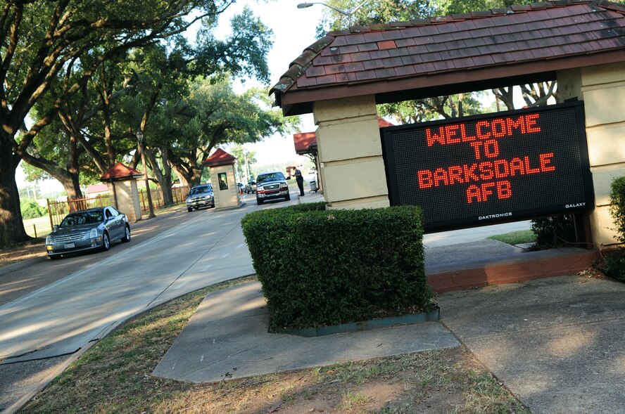 BARKSDALE AIR FORCE BASE, La. -- Officers from Pinkerton Security Service scan the identification cards of Air Force personnel at the Shreveport Gate Aug. 26. Beginning Sept. 6 all Barksdale personnel are required to have their identification cards registered in the Defense Biometric Identification System. DBIDS is a Department of Defense biometric system that allows the installation guards to see everything about a registered user. (U.S. Air Force photo by Senior Airman Joanna M. Kresge)