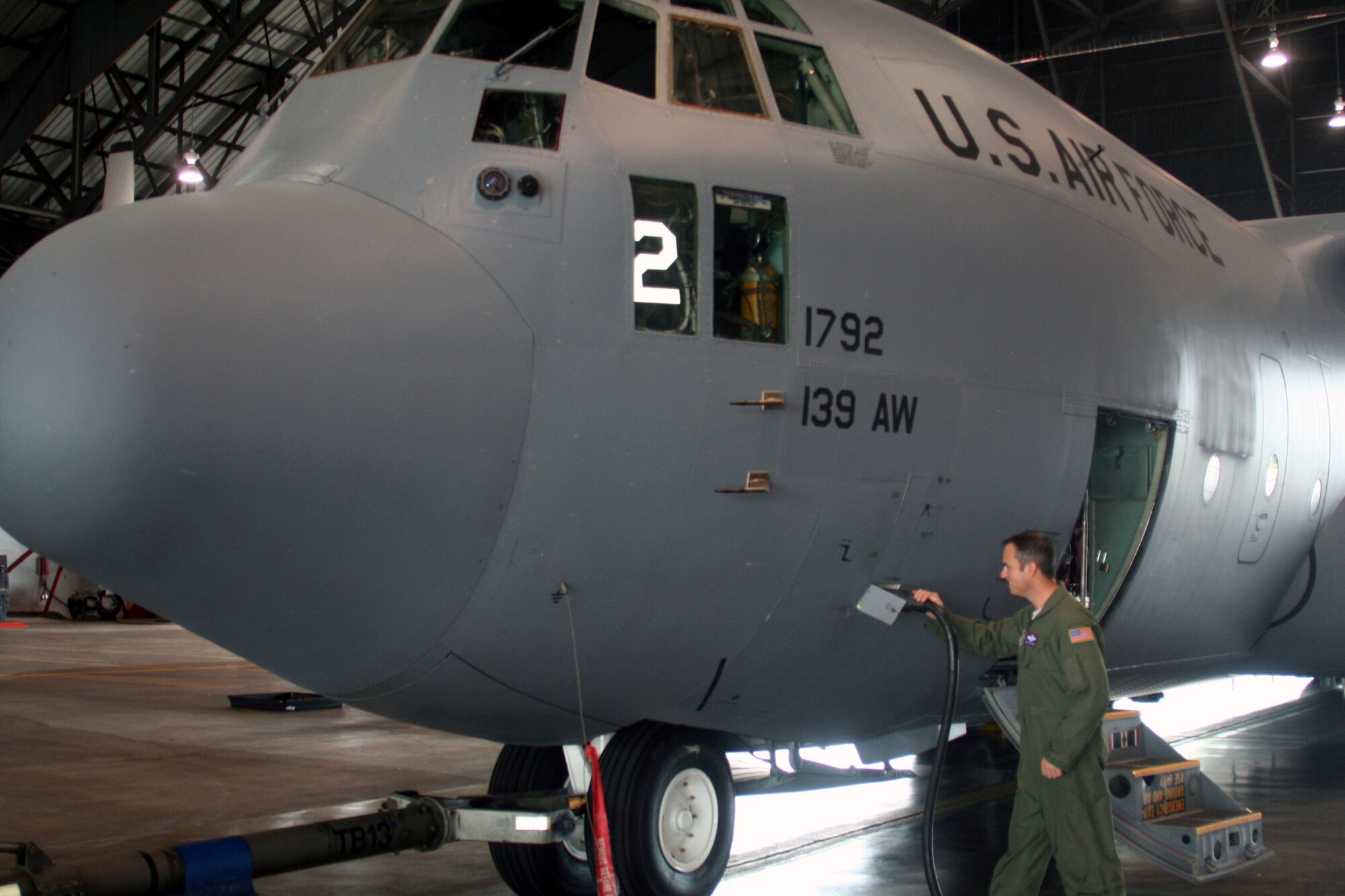 Master Sgt. John Gorsuch, C-130 Hercules loadmaster and instructor for Air Mobility Command's Detachment 5 at the Advanced Airlift Tactics Training Center at St. Joseph, Mo., looks over a C-130 aircraft display at Scott Air Force Base, Ill., on Aug. 20, 2010. (U.S. Air Force Photo/Master Sgt. Scott T. Sturkol)