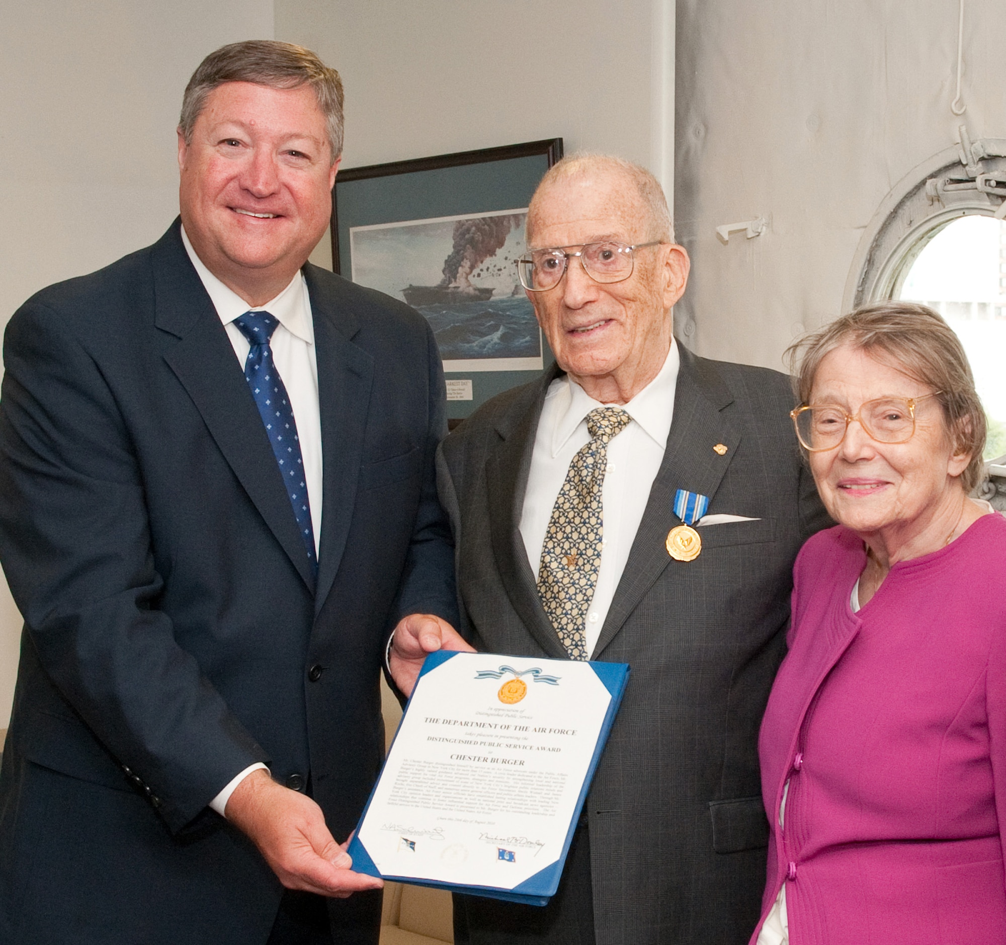 Secretary of the Air Force Michael Donley (left) presented Chester Burger (center) and his wife Elizabeth (right) the Air Force Distinguished Public Service Award Aug. 24, 2010, for his service as an Air Force advocate under the Public Affairs Advisory Group in New York City for more than 15 years. (U.S. Air Force photo/Lance Cheung)