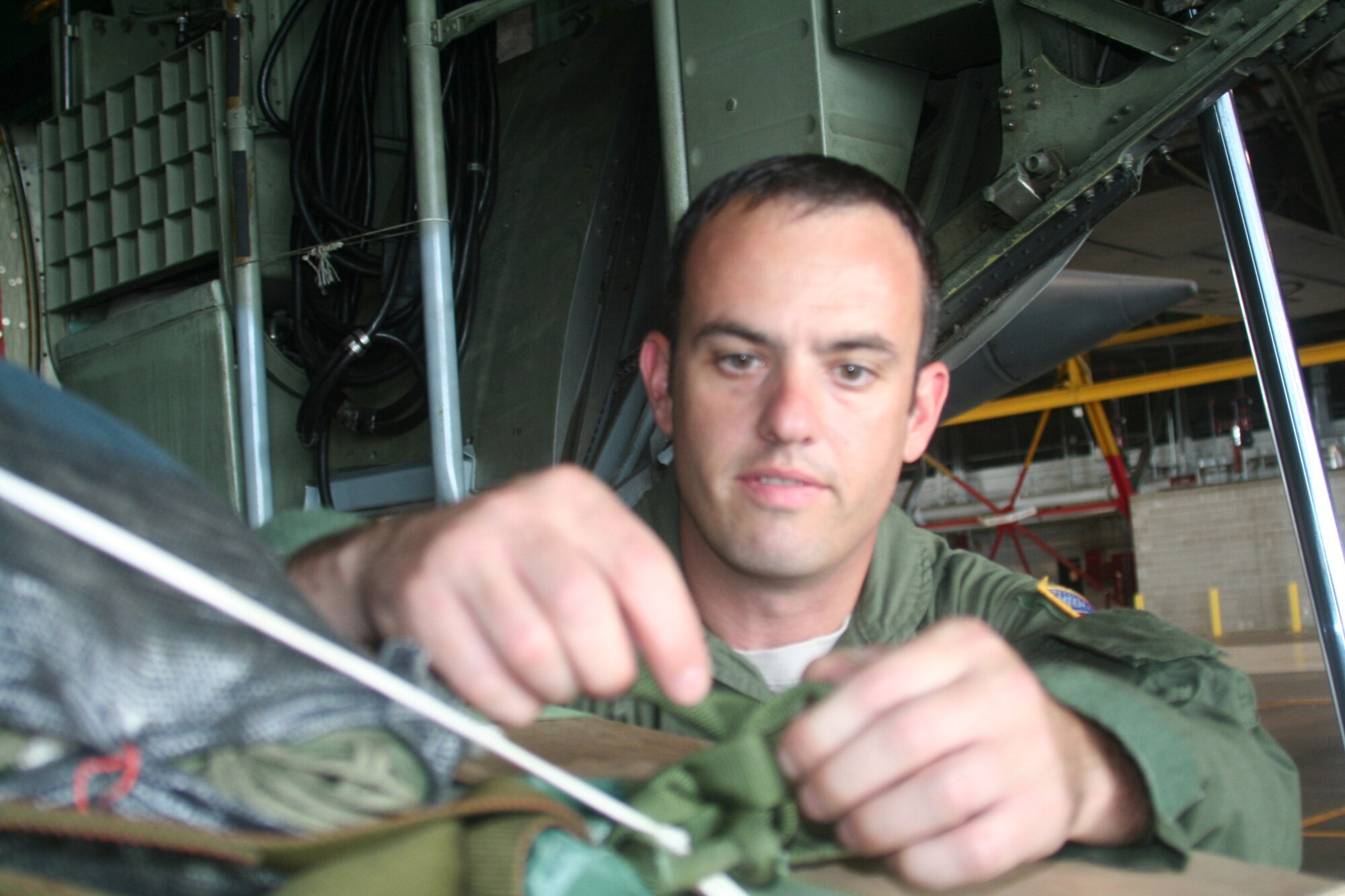 Master Sgt. John Gorsuch, C-130 Hercules loadmaster and instructor for Air Mobility Command's Detachment 5 at the Advanced Airlift Tactics Training Center at St. Joseph, Mo., checks the set up of an airdrop container delivery system bundle for a C-130 aircraft display at Scott Air Force Base, Ill., on Aug. 20, 2010. (U.S. Air Force Photo/Master Sgt. Scott T. Sturkol)