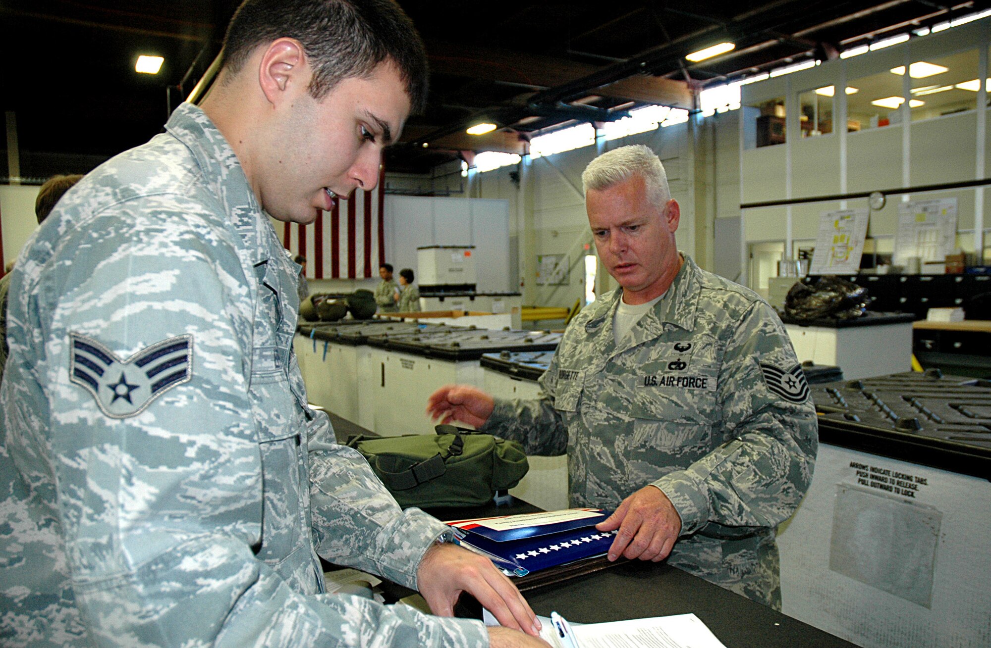 JOINT BASE LEWIS-MCCHORD, Wash., - Tech. Sgt. Scott Georgette, 36th Aerial Port Squadron, reviews paperwork in the deployment processing line Aug. 25 here. Sergeant Georgette is one of more than 60 Reservists from the 446th Airlift Wing deploying in the next two weeks to various locations in Southwest Asia. (U.S. Air Force photo/Sandra Pishner)