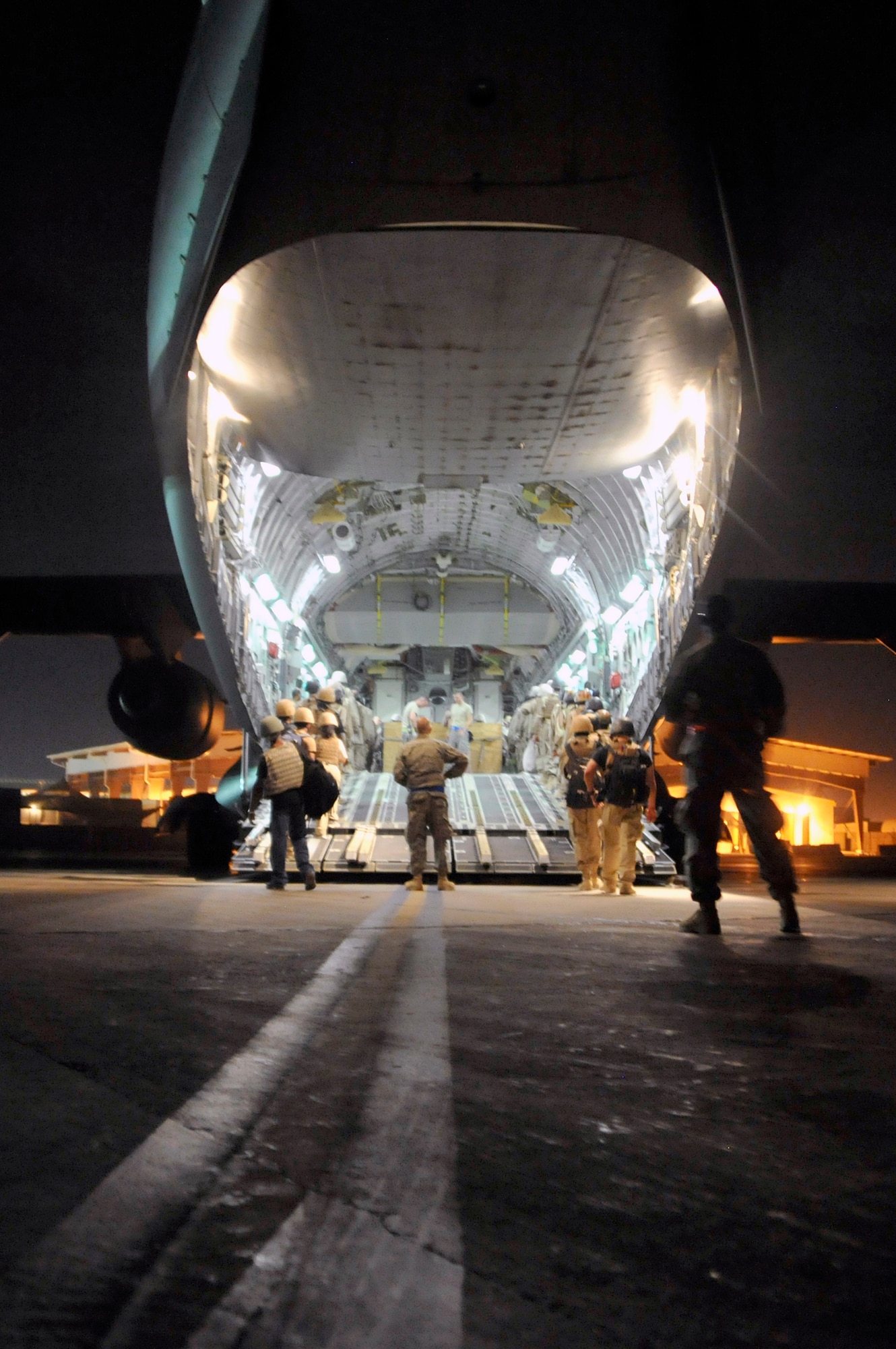 Aerial porters from 447th Expeditionary Logistics Readiness Squadron oversee the loading of contractors heading to bases throughout Iraq Aug. 6, 2010, at Sather Air Base, Iraq, Aug. 6, 2010. (U.S. Air Force photo/Senior Airman Perry Aston)