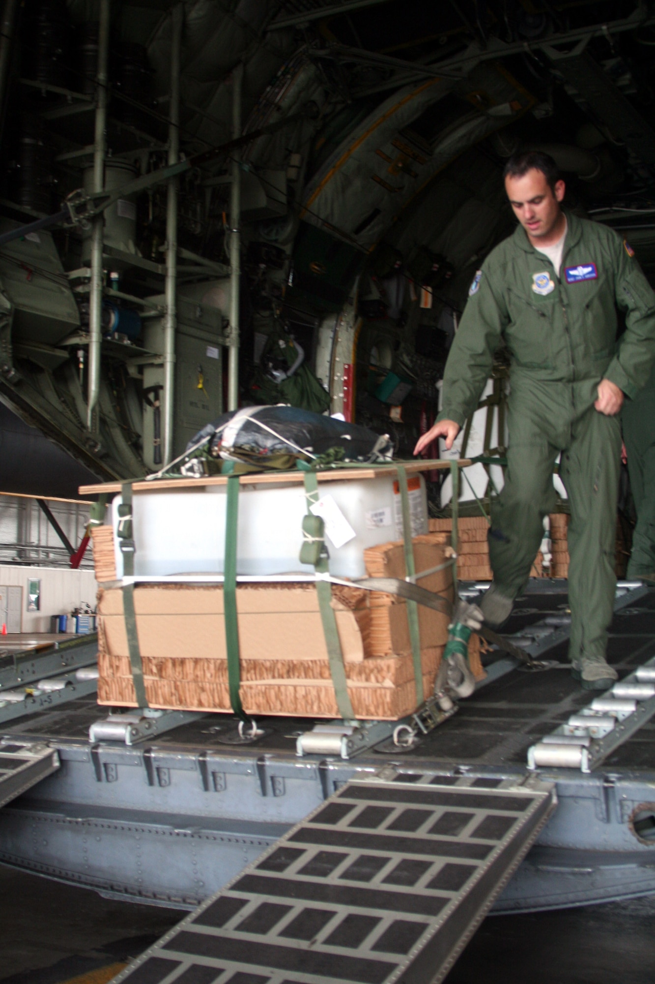 Master Sgt. John Gorsuch, C-130 Hercules loadmaster and instructor for Air Mobility Command's Detachment 5 at the Advanced Airlift Tactics Training Center at St. Joseph, Mo., checks the set up of an airdrop container delivery system bundle for a C-130 aircraft display at Scott Air Force Base, Ill., on Aug. 20, 2010. (U.S. Air Force Photo/Master Sgt. Scott T. Sturkol)