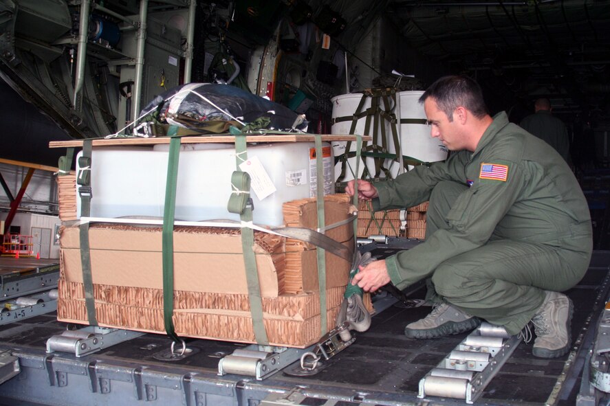 Master Sgt. John Gorsuch, C-130 Hercules loadmaster and instructor for Air Mobility Command's Detachment 5 at the Advanced Airlift Tactics Training Center at St. Joseph, Mo., checks the set up of an airdrop container delivery system bundle for a C-130 aircraft display at Scott Air Force Base, Ill., on Aug. 20, 2010. (U.S. Air Force Photo/Master Sgt. Scott T. Sturkol)