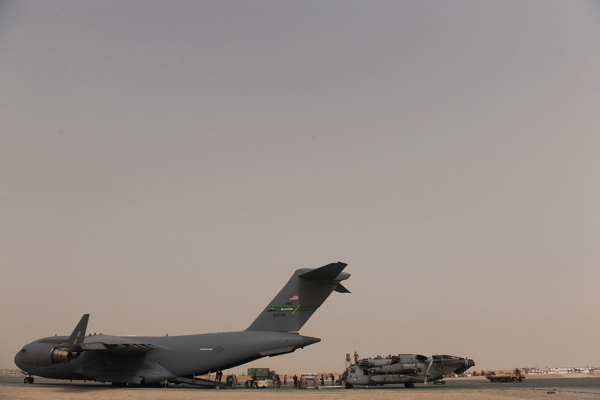Aircrew assigned to the10th and 6th Airlift Squadrons and U.S. Marines assigned to the 266th Medium Tilt Rotor Squadron, finish unloading a U.S. Marine Corps MH-53E Super Stallion out of a C-17A Globemaster III aircraft from Joint Base Lewis-McChord, Wash., on Aug. 26, 2010 at Camp Bastion, Afghanistan. The equipment and personnel are in support of the Pakistan flood relief efforts. (U.S. Air Force photo/Staff Sgt. Manuel J. Martinez)