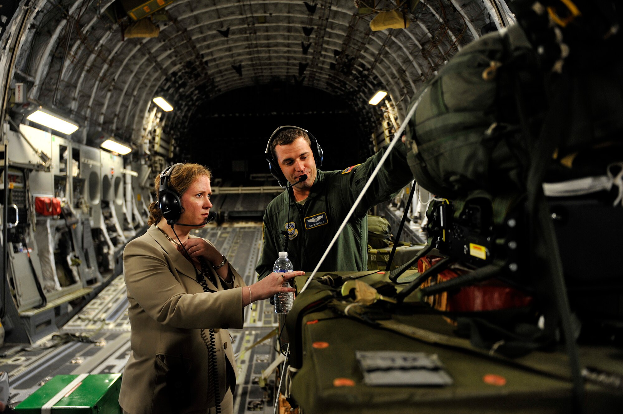 Under Secretary of the Air Force Ms. Erin C. Conaton speaks with Capt. David Myrick, from the 14th Airlift Squadron, onboard a C-17 Globemaster III aircraft from Joint Base Charleston, S.C., over Virginia, Aug. 19, 2010.  Ms. Conaton was given several demonstrations on the capabilities of the C-17 during her flight such as precision air drop and aeromedical evacuation.  (U.S. Air Force photo by Staff Sgt. Michael B. Keller/Released)

