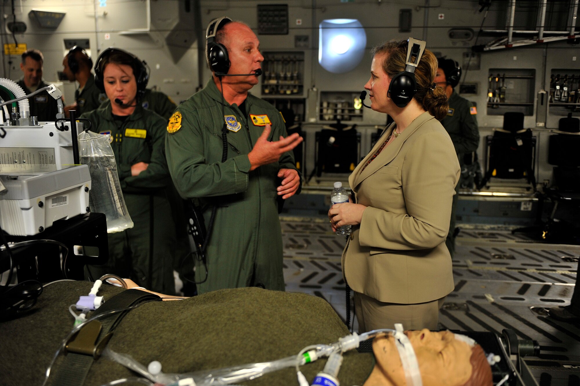 Under Secretary of the Air Force Ms. Erin C. Conaton speaks with Capt. J. Stephen Grant from the 920th Aeromedical Medical Staging and Training Squadron, Patrick Air Force Base, Fla., on board a C-17 Globemaster III aircraft from Joint Base Charleston, S.C., over Virginia, on Aug. 19, 2010.  Ms. Conaton was given several demonstrations on the capabilities of the C-17 during her flight such as precision air drop and aeromedical evacuation.  (U.S. Air Force Photo/Staff Sgt. Michael B. Keller)
