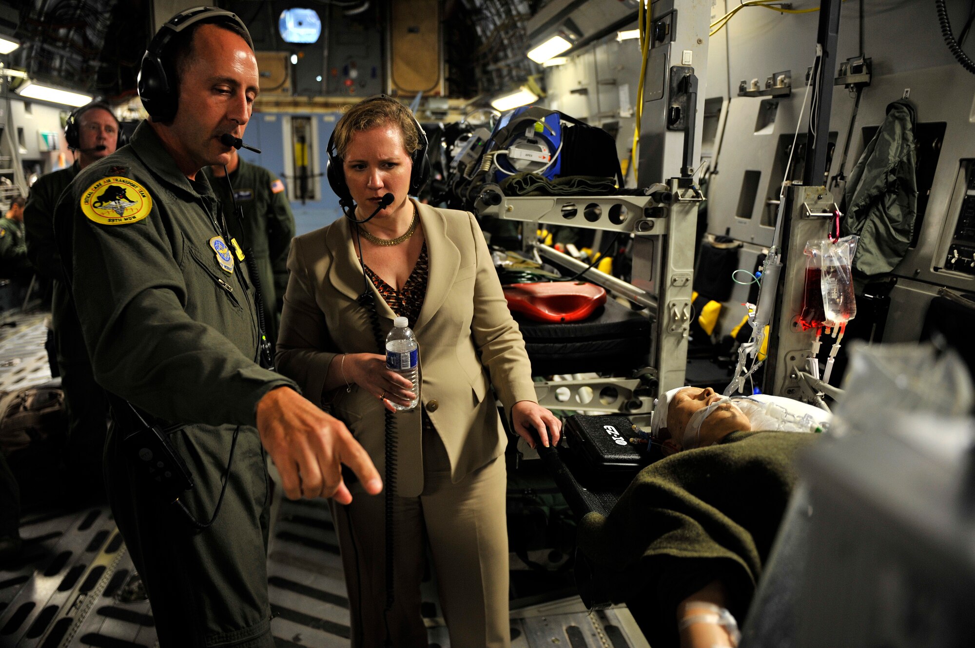 Under Secretary of the Air Force Ms. Erin C. Conaton speaks with Maj. J.T. Swick, a Critical Care Air Transport Team member from the 59th Medical Wing, Lackland Air Force Base, Texas, onboard a C-17 Globemaster III aircraft from Joint Base Charleston, S.C., over Virginia, on Aug. 19, 2010.  Ms. Conaton was given several demonstrations on the capabilities of the C-17 during her flight such as precision air drop and aeromedical evacuation.  (U.S. Air Force Photo/Staff Sgt. Michael B. Keller)
