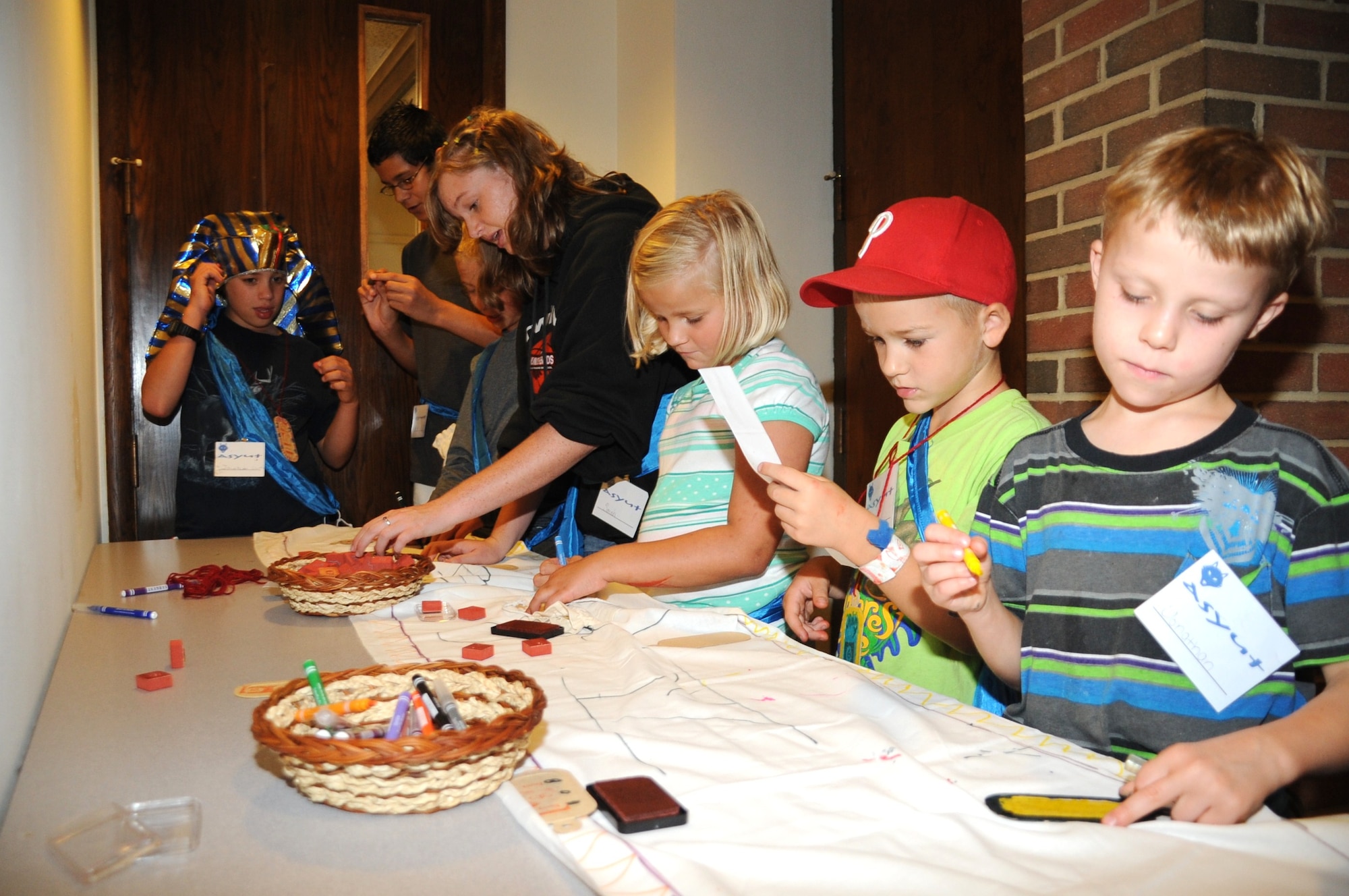 Children work on arts-and-crafts projects during a summer family event titled “Egypt: Joseph’s Journey from Prison to Palace” held Aug. 16 through Aug. 20 at the McGuire North Chapel. The event included teamwork-building games, Egyptian foods and biblical stories told by volunteers from the Protestant and Catholic communities. (U.S. Air Force photo/Airman 1st Class Bryan Swink)