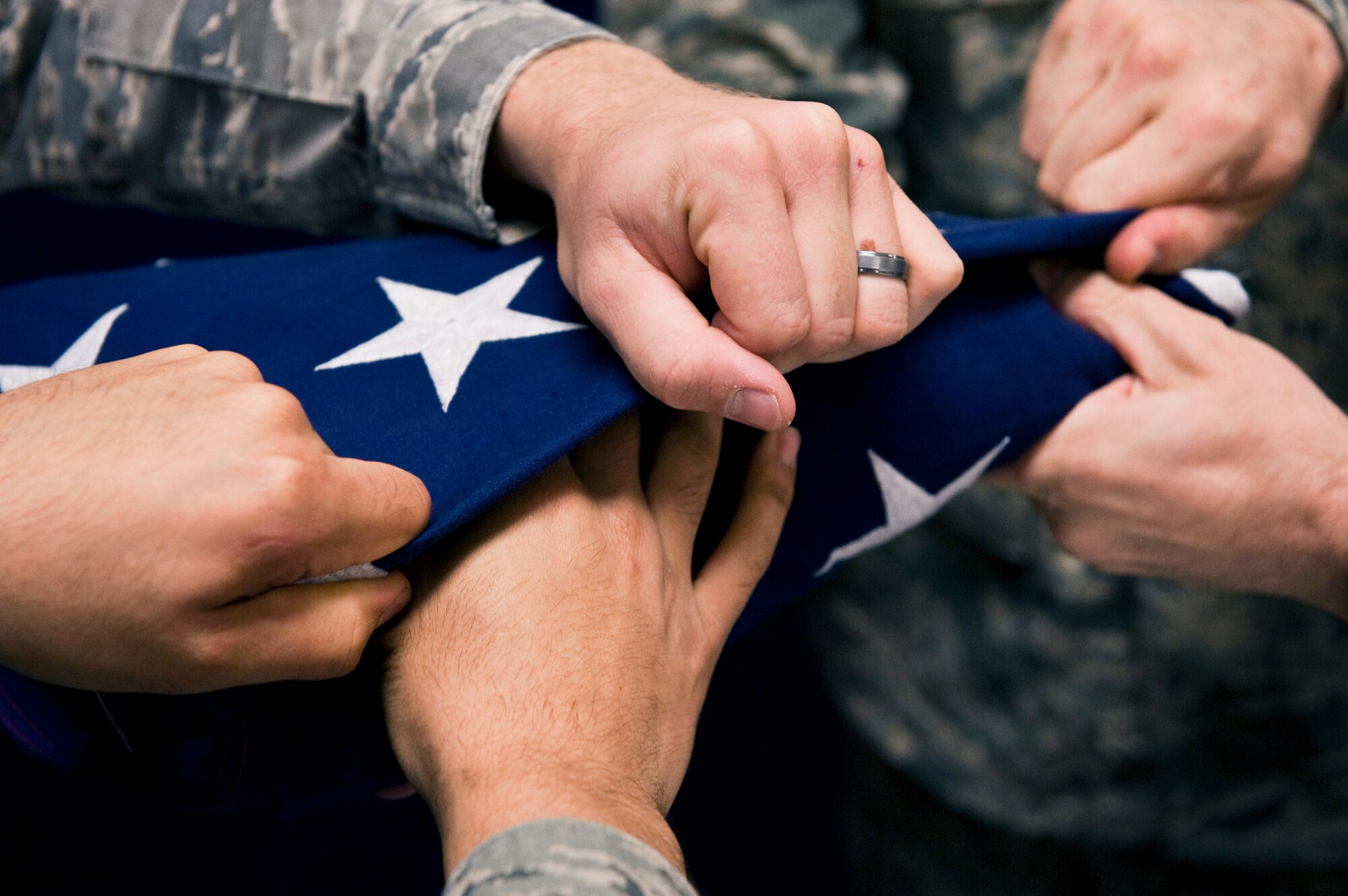 Members of the honor guard fold the flag during a practice session Aug. 19, 2010, at Joint Base Elmendorf-Richardson, Alaska. (U.S. Air Force photo/Airman 1st Class Christopher Gross)
