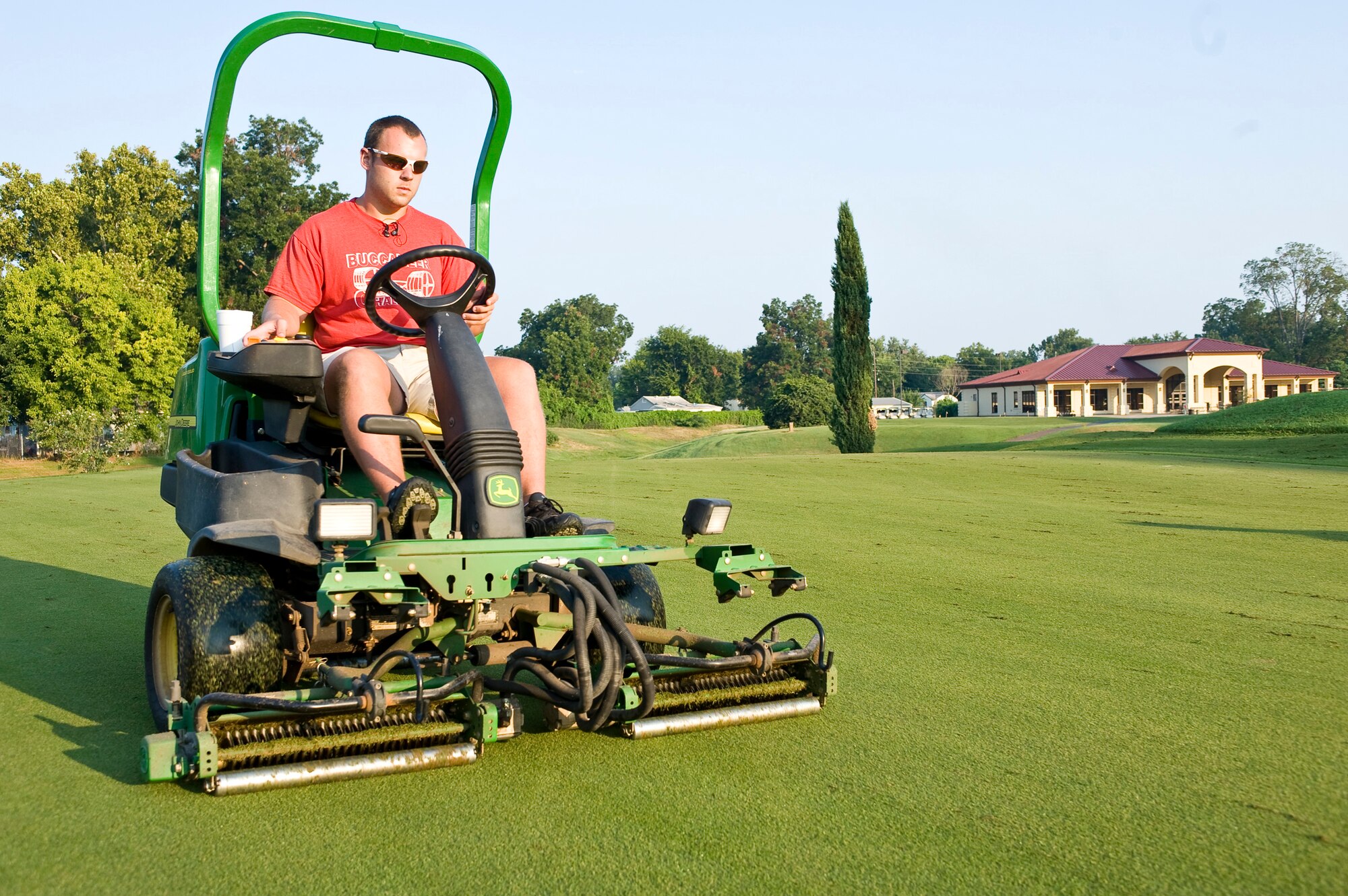 BARKSDALE AIR FORCE BASE, La. -- Calvin Adkins, Fox Run golf course maintenance crew member, uses a specialized mower called a verticutter to remove thatch from one of the greens Aug. 25. Thatch is a layer of material that builds up between the grass and the soil and if not removed can prevent moisture and nutrients from reaching the roots. (U.S. Air Force photo by Senior Airman Chad Warren)(RELEASED)
