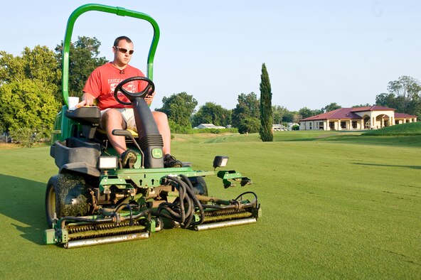 BARKSDALE AIR FORCE BASE, La. -- Calvin Adkins, Fox Run golf course maintenance crew member, uses a specialized mower called a verticutter to remove thatch from one of the greens Aug. 25. Thatch is a layer of material that builds up between the grass and the soil and if not removed can prevent moisture and nutrients from reaching the roots. (U.S. Air Force photo by Senior Airman Chad Warren)(RELEASED)