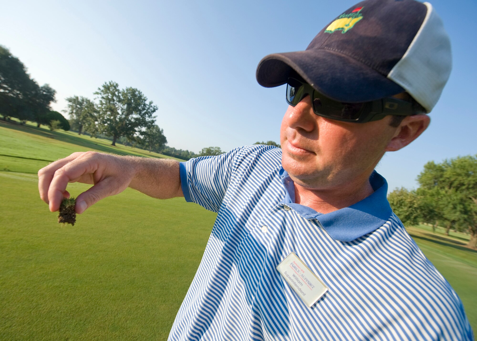 BARKSDALE AIR FORCE BASE, La. -- William Duckworth, Fox Run golf course superintendent, checks the thatch layer in a plug of soil from one of the greens Aug. 24. Thatch is a layer of material that builds up between the grass and the soil and if not removed can prevent moisture and nutrients from reaching the roots. (U.S. Air Force photo by Senior Airman Chad Warren)(RELEASED)