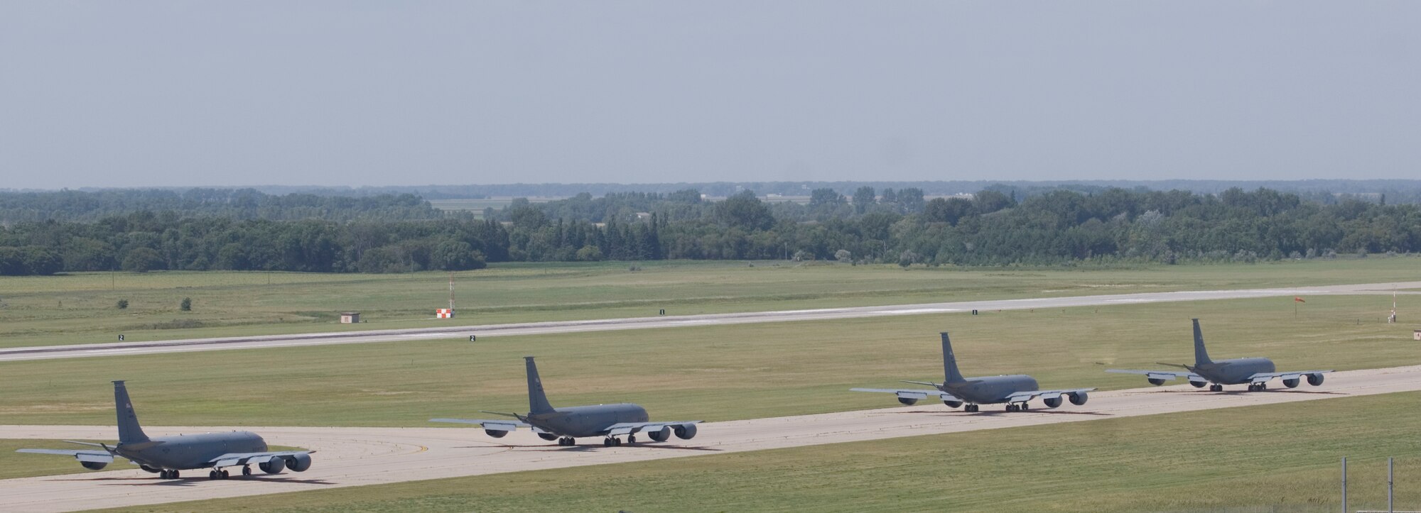 Four of McConnell’s 63 KC-135 Stratotankers taxi down the flightline before takeoff during an operational readiness exercise Aug. 17, 2010, Grand Forks Air Force Base, N.D.  The exercise began Aug. 15 and required more than 100 Airmen to deploy to Grand Forks.  (U.S. Air Force photo/Senior Airman Abigail Klein)