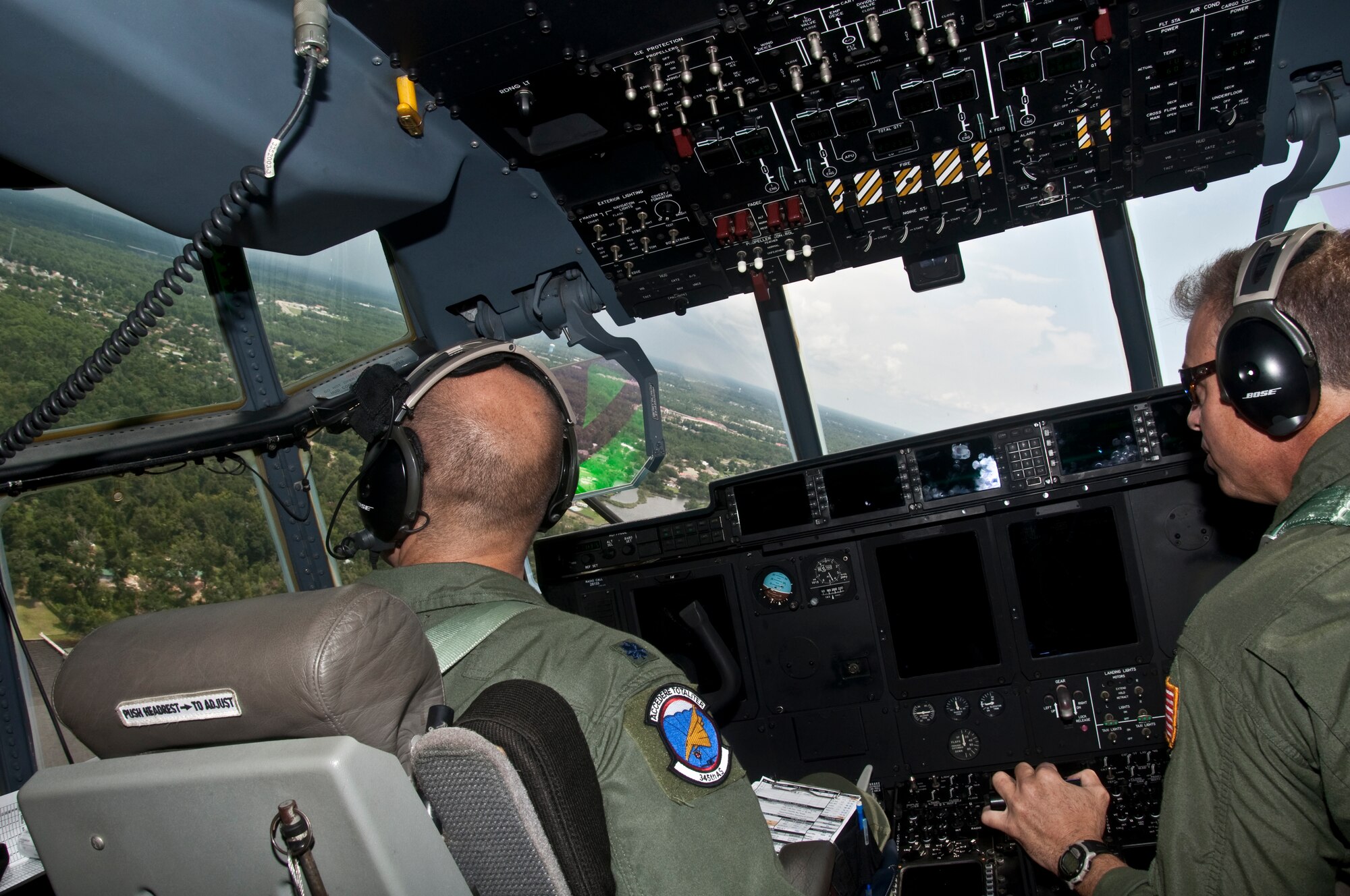 Lt. Col. Mike Ramirez, 345th Airlift Squadron and Lt. Col. Keith Gibson, 815th AS, fly a routine air drop training mission Aug. 19 over Camp Shelby, Hattiesburg, Miss. The 345th AS was recently reactivated as an active associate unit to the 815thAS and the 403rd Wing. This partnering provides both the active-duty members and Reservists with the opportunity to work and train together, as well as reduce operational costs. During the mission, combat maneuvering of the C-130J-30 “Super Hercules” was executed, in addition to dropping two training pallets. (U. S. Air Force photo/Master Sgt. Daniel Nathaniel)