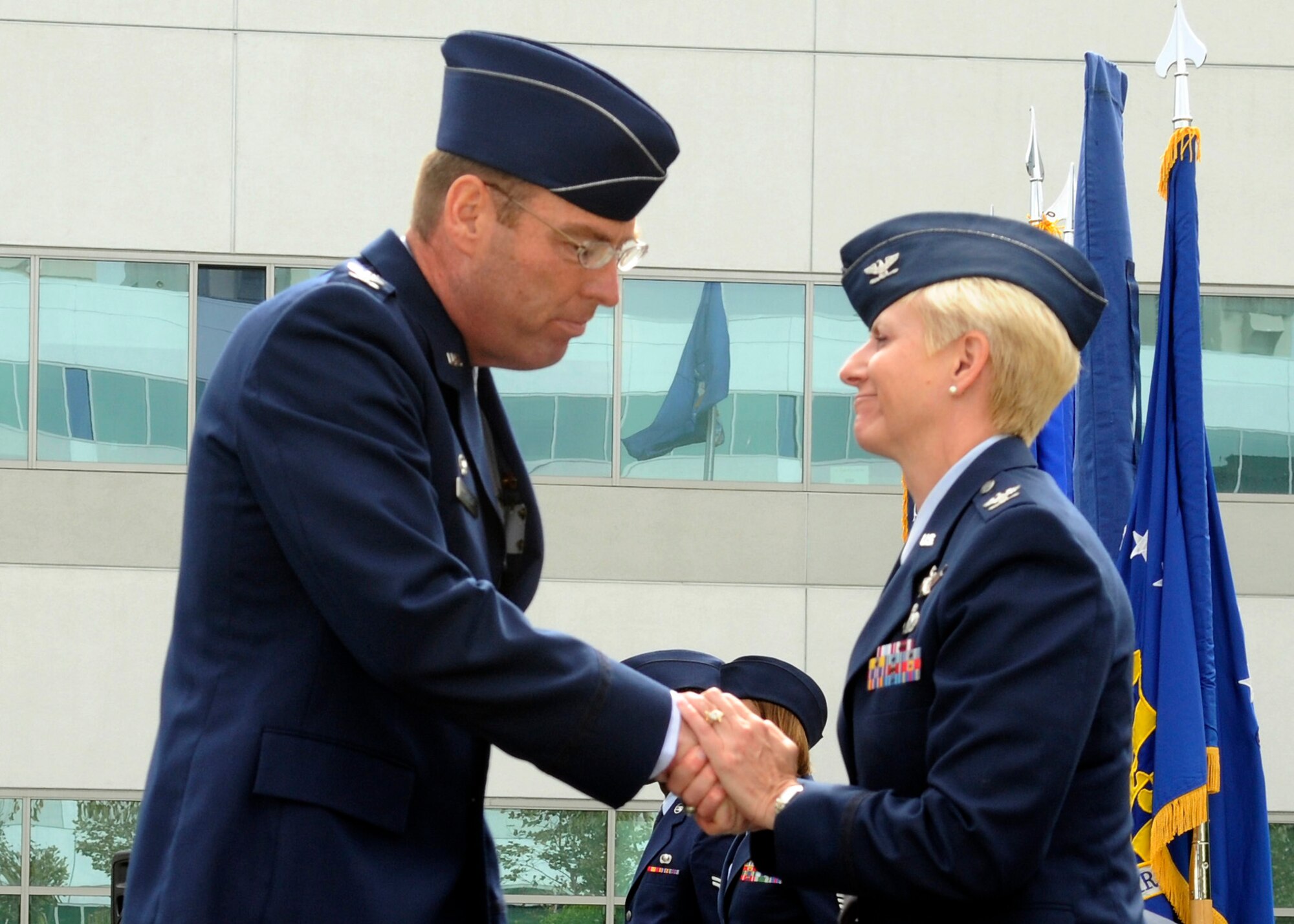 Retiring 61st Air Base Wing Commander, Col. Anita Latin welcomes the new 61st Air Base Group Commander, Col. Frank Simcox.  (Photo by Jim Gordon)