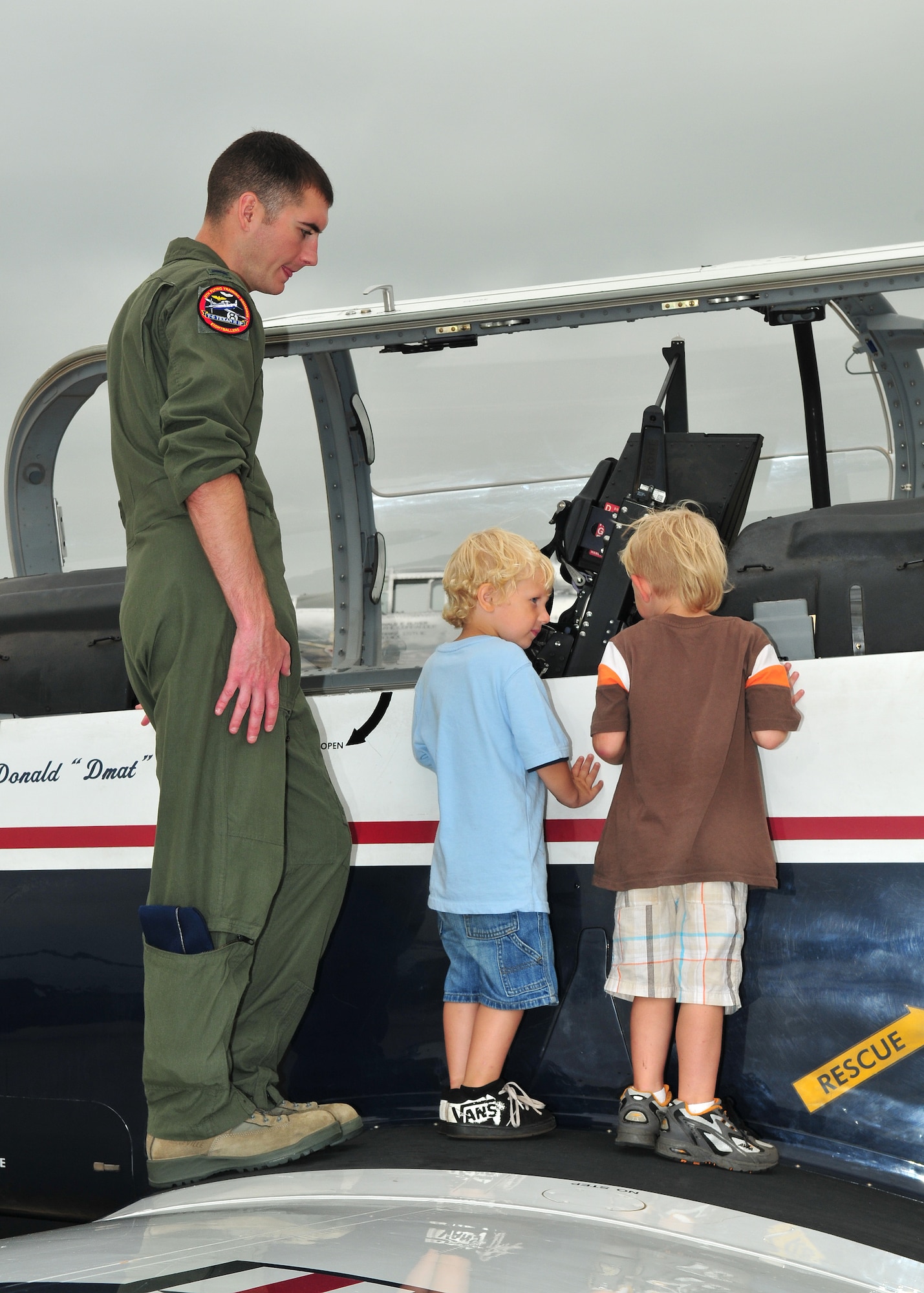 1st Lt. James Brantly from the 71st Flying Training Wing, Vance AFB, Oklahoma, gives young aviation enthusiasts an up close look at the T-6 Texan II trainer during the Volk Field Air National Guard Base open house on August 21, 2010. Despite inclement weather, the Volk Field Open house attracted approximately 3000 visitors, 20 military and civilian aircraft, numerous vendors, and aerial performers from across the country. (U.S. Air Force photo by Master Sgt. Paul Gorman)