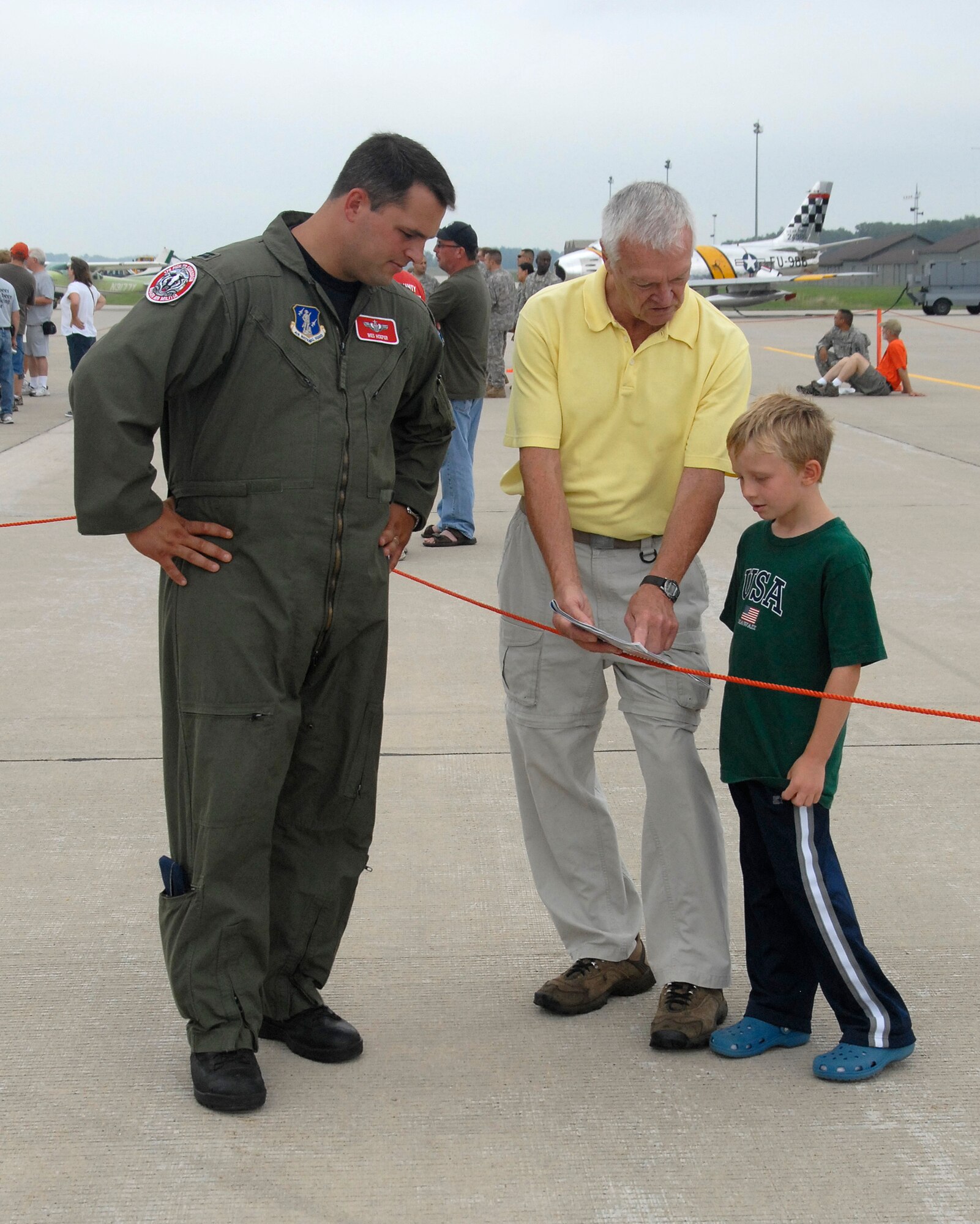 Volk Field range officer and F-16 pilot Capt. Wes Hoeper answers questions about the F-16 Fighting Falcon to attendees of the Volk Field Air National Guard Base open house on August 21, 2010. Despite inclement weather, the Volk Field Open house attracted approximately 3000 visitors, 20 military and civilian aircraft, numerous vendors, and aerial performers from across the country.(U.S. Air Force photo by Staff Sgt. Christen Bloomfield)