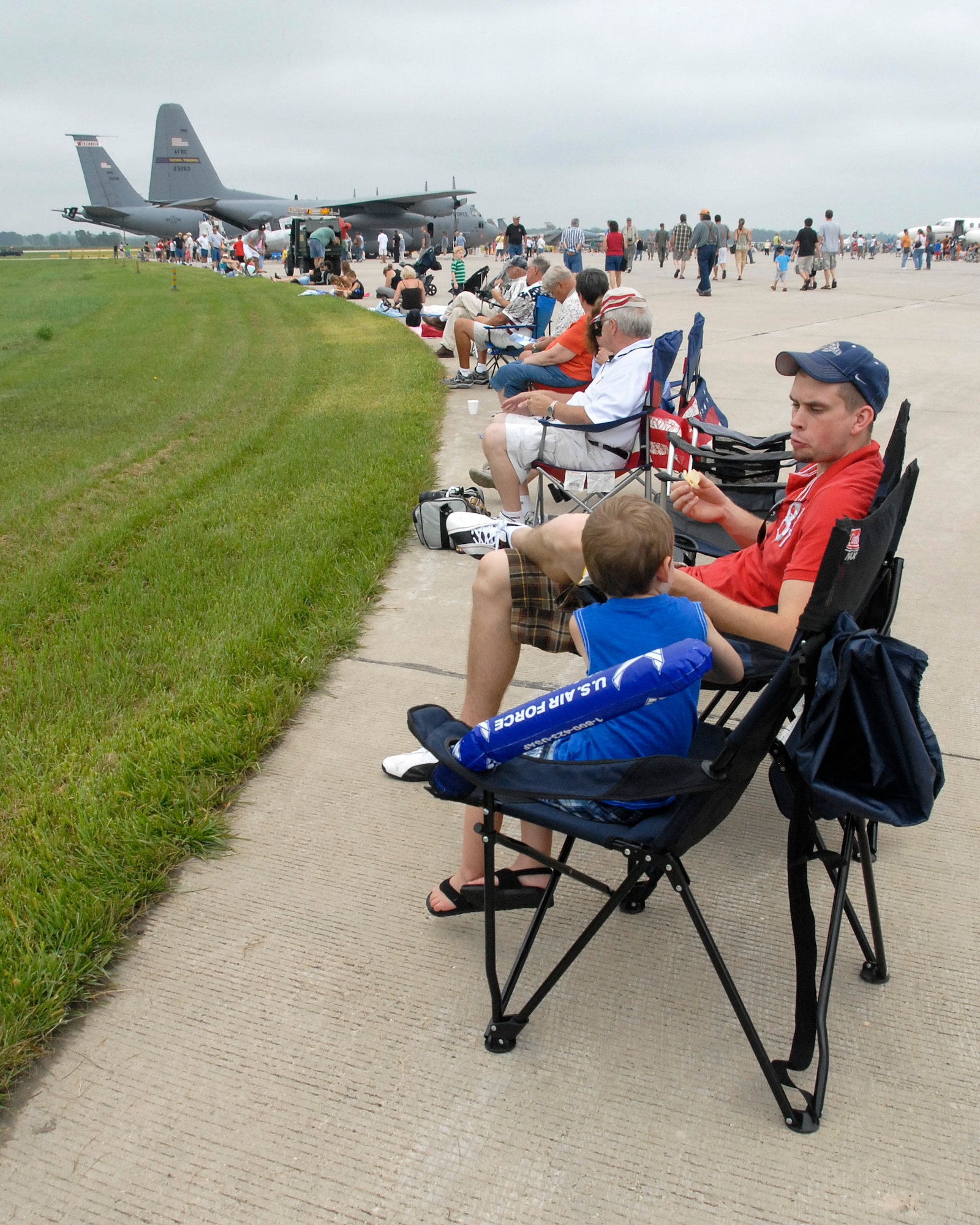 An enthusiastic crowd lines the aircraft ramp at the Volk Field Air National Guard Base open house on August 21, 2010. Despite inclement weather, the Volk Field open house attracted approximately 3000 visitors, 20 military and civilian aircraft, numerous vendors, and aerial performers from across the country. (U.S. Air Force photo by Staff Sgt. Christen Bloomfield)