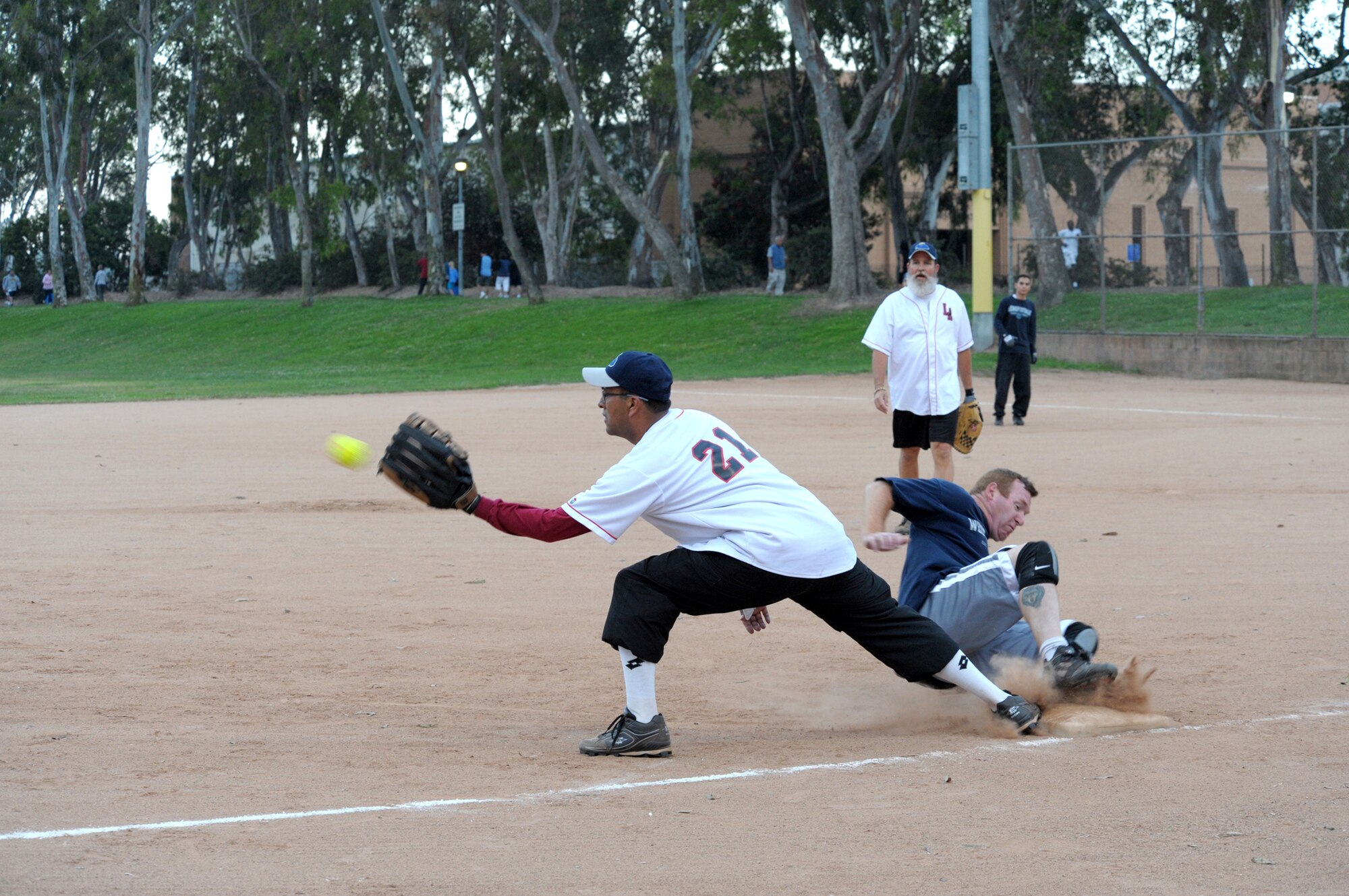Senior Master Sgt. Glen Jimenez, LA Storm softball team, catches the ball as a player from the opposing team slides into base during a recent game played in Torrance. (Photo by Joe Juarez)