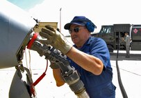 MINOT AIR FORCE BASE, N.D. – Darrell Stambaugh of Transient Alert removes a fuel hose from an A-10 Thunderbolt II while Airman 1st Class David Peterson, 5th Logistics Readiness Squadron refueling equipment operator,  operates the fuel truck here Aug. 24.  The A-10 Thunderbolt II received modifications at Mountain Home AFB, Id., and made the stop for fuel and routine maintenance en route to Whiteman AFB, Mo.  (U.S. Air Force photo by Staff Sgt. Miguel Lara III)