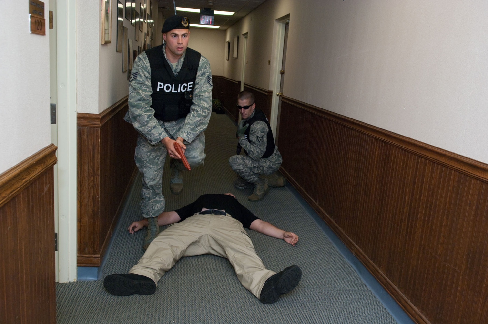 HANSCOM AIR FORCE BASE, Mass. – After taking down the “active shooter,” Staff Sgt. Chad Hildreth proceeds down the hallway in Building 1605 to continue searching the building while Tech. Sgt. Timothy Gatherum waits on Aug. 19. In the wake of the tragic shootings that took place recently in a workplace setting in Connecticut, as well as last November at Fort Hood, Texas, bases throughout the military are evaluating their own procedures and capabilities for handling an active shooter, should such an event take place on their doorstep. This exercise was part of a series of exercises to test the readiness of many of Hanscom’s emergency services. (U.S. Air Force photo by Rick Berry)