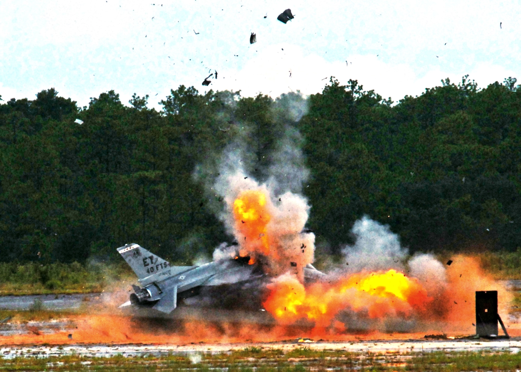 An F-16 Fighting Falcon explodes, sending debris and shrapnel into the air Aug. 19, 2010, on the range at Eglin Air Force Base, Fla. The explosion was a static test of the flight termination system to be used in the QF-16, a supersonic reusable full-scale aerial target drone modified from an F-16. The purpose of the test was to demonstrate that the FTS design will be sufficient to immediately terminate the flight of a QF-16, as well as to determine a range safety debris footprint. (U.S. Air Force photo/Samuel King Jr.) 