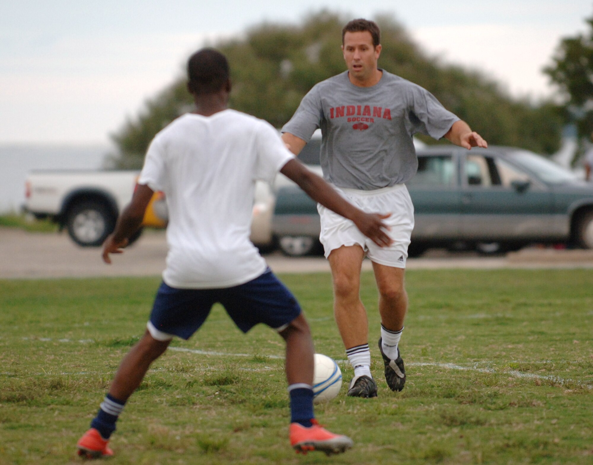 LANGLEY AIR FORCE BASE, Va. -- Maj. Steven Robertson, 633d Dental Squadron chief of oral and maxillofacial surgery and coach of the Langley men’s varsity soccer team, negotiates a defender during practice at the Langley athletic fields Aug. 25. Major Robertson will join 18 teammates on a trip to Texas Sept. 2 to participate in the Defender's Cup, a nationwide invitational military tournament over the Labor Day weekend, hosted by Joint Base San Antonio. (U.S. Air Force photo/Airman 1st Class Jason J. Brown)