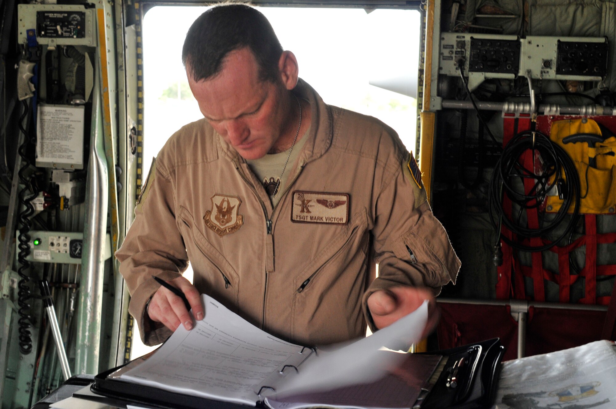Tech. Sgt. Mark Victor, HC-130P/N Hercules aircraft loadmaster, checks the forms on the plane during its pre-flight inspection pror to taking of for Africa for a two-month deployment. Approximately 60 Airmen from the 920th Rescue Wing will be deployed to the Horn of Africa region providing combat search and rescue support. (U.S. Air Force Photo/Staff Sgt. Stephen Collier)