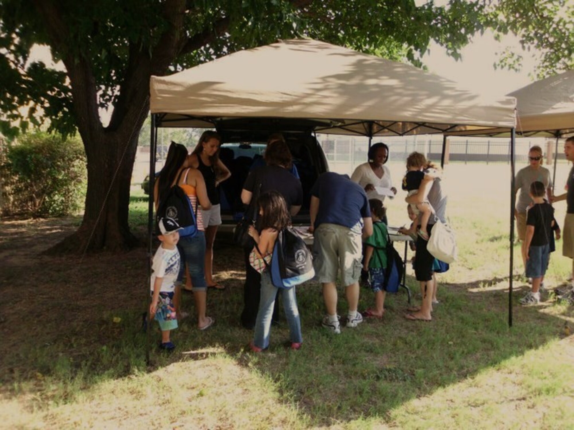 Sheppard families receive back-to-school backpacks filled with school supplies Aug. 21, before starting the new school year. The Sheppard Chapel held the back-to-school event to bring military families together before the school year began. The school supplies were funded by the church tides and offerings from the community and were set aside for this event. (U.S. Air Force photo/ Tech. Sgt. Brian Schaaf)