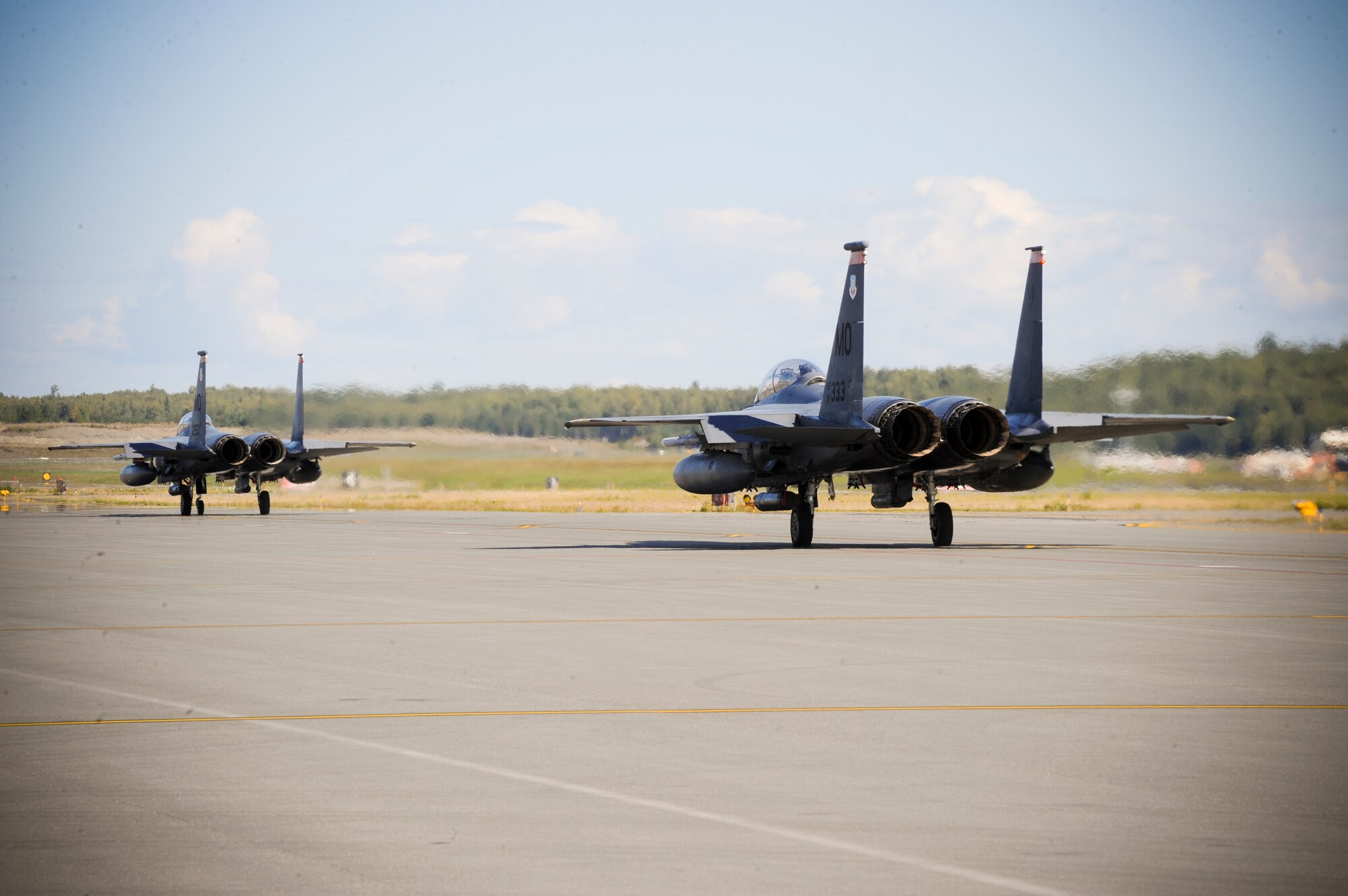 JOINT BASE ELMENDORF-RICHARDSON, Alaska -- Two F-15E Strike Eagle, from the 391st Fighter Squadron out of Mountain Home Air Force Base, Idaho, taxi the runway here Aug. 25. The 391st FS is currently assigned to Joint Base Elmendorf-Richardson for a temporary duty assignment to aid in training exercises for the F-22 Raptor Squadrons stationed here. (U.S. Air Force Photo by Staff Sgt. Joshua Garcia)