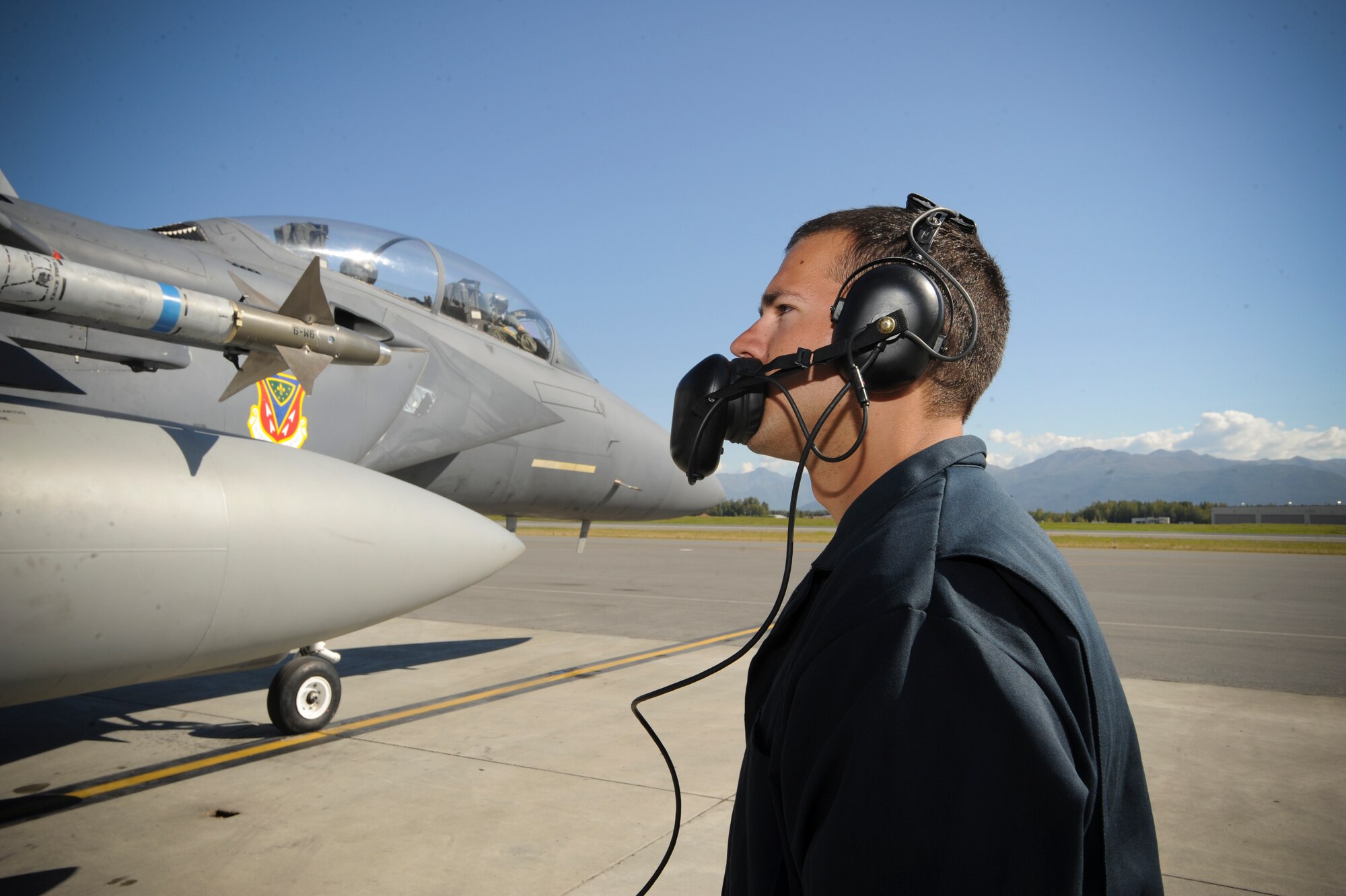 JOINT BASE ELMENDORF-RICHARDSON, Alaska -- Senior Airman Kyle Wood, 391st Aircraft Maintenance Unit, talks to Capt. David Gunter, a pilot for the 391st Fighter Squadron, during preflight prior to taking off for a sortie here, Aug. 25. The 391st Fighter Squadron is currently TDY to Joint Base Elmendorf-Richardson from Mountain Home Air Force Base, Idaho, to aid in F-22 Raptor training. (U.S. Air Force Photo by Staff Sgt. Joshua Garcia)