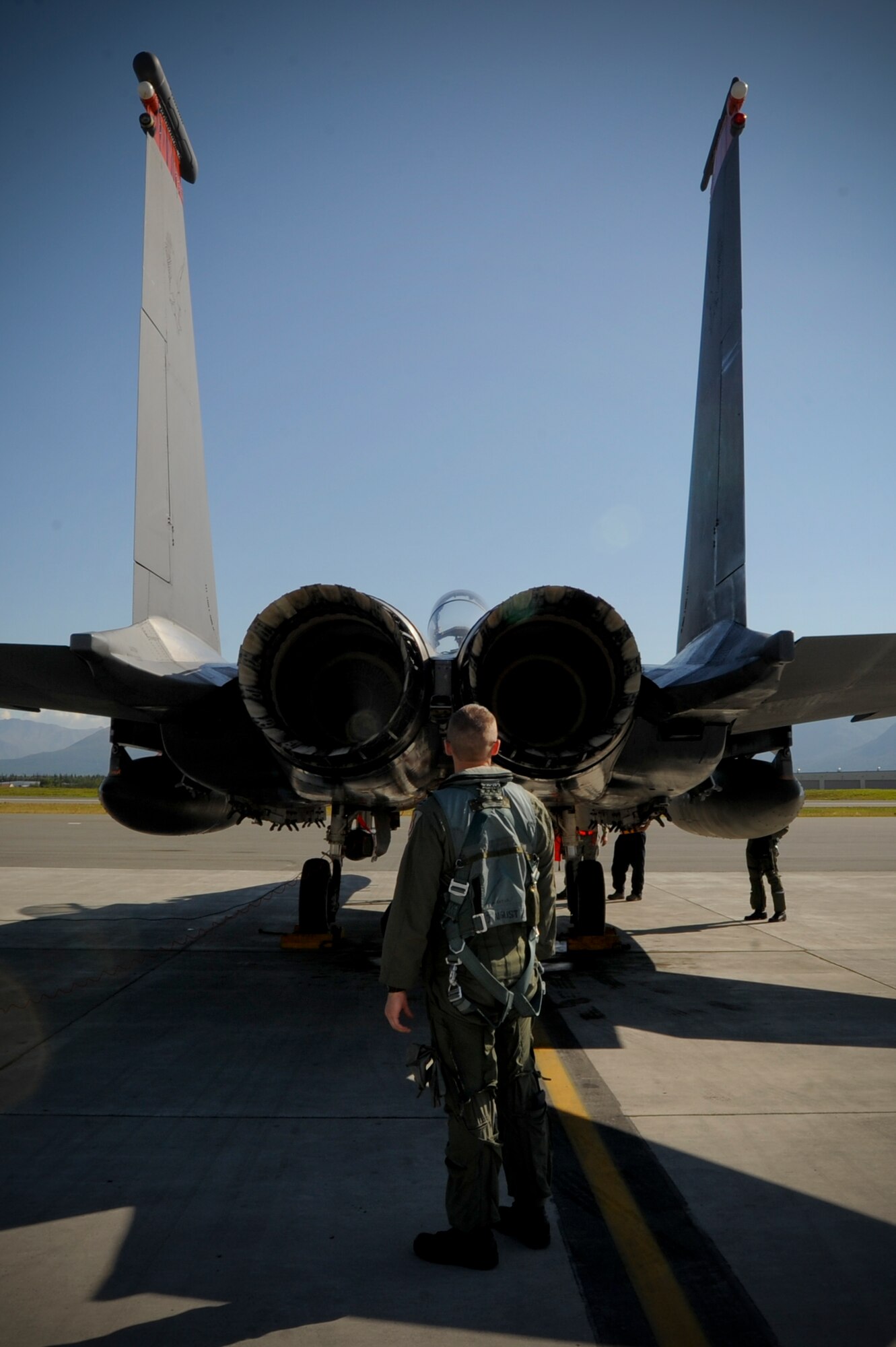 JOINT BASE ELMENDORF-RICHARDSON, Alaska -- Capt. David Gunter, fighter pilot with the 391st Fighter Squadron, inspects the exhaust of an F-15E Strike Eagle during pre-flight. The 391st Fighter Squadron is currently TDY to Joint Base Elmendorf-Richardson from Mountain Home Air Force Base, Idaho, to aid in F-22 Raptor training. (U.S. Air Force Photo by Staff Sgt. Joshua Garcia)