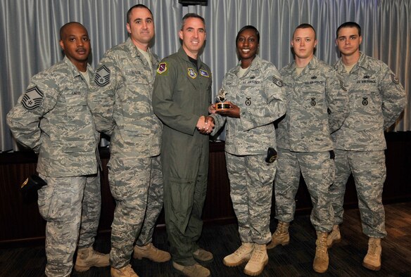 The Golden Knight recipient for June is the 21st Security Forces Squadron plans and programs branch. Team members include Senior Master Sgt. Shaun Guilfoil, Master Sgt. Frank Green, Tech. Sgt. Joseph Anderson, Staff Sgt. Michael Smith, and Staff Sgt. La’Tanya Ferguson. (Air Force photo/Rob Bussard)
