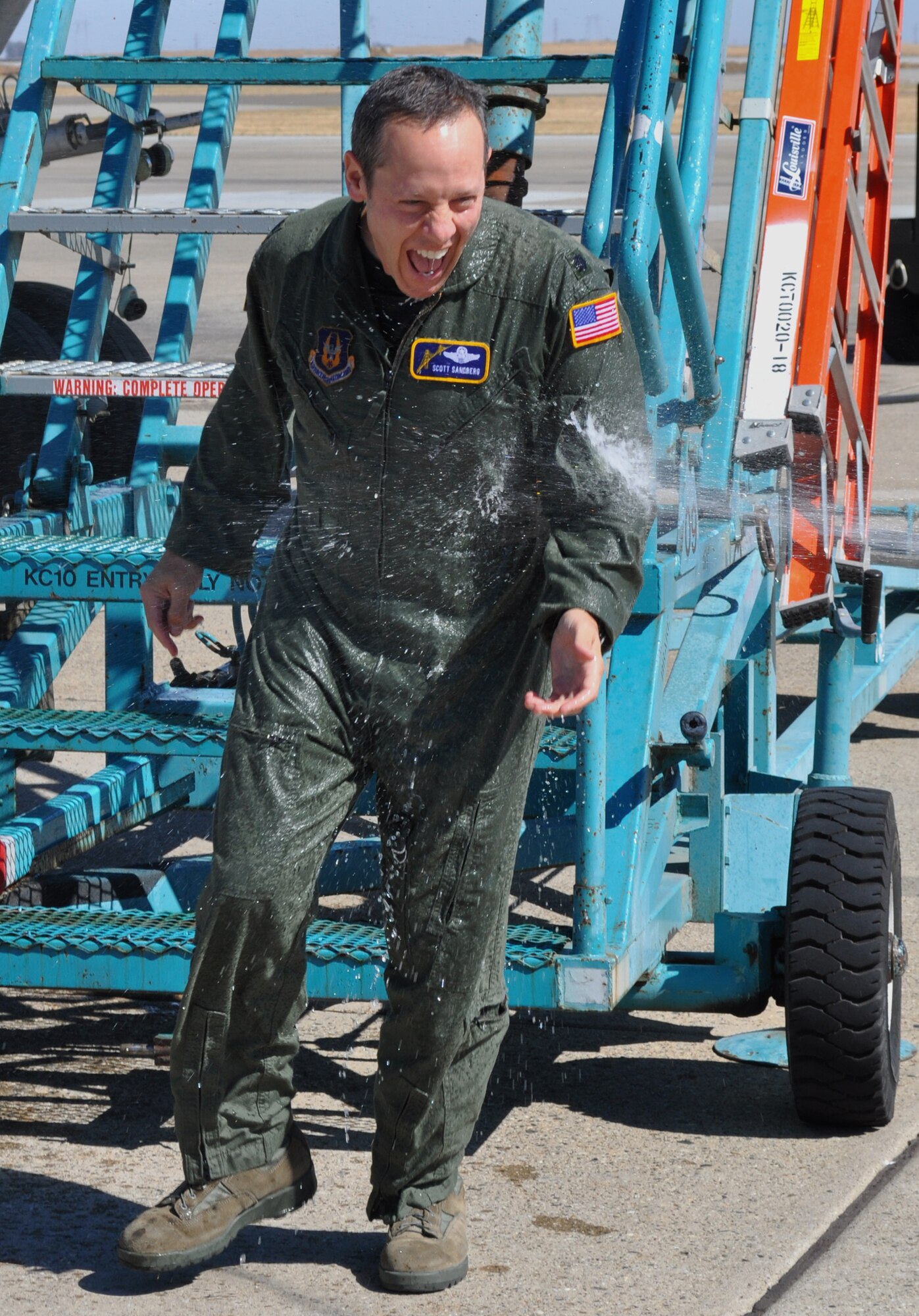 Lt. Col. Scott D. “Scooter” Sandberg gets a good dousing at the conclusion of his ‘fini’ flight here at Travis recently. Lt. Col. Sandberg has taken a position at Beale AFB after serving with both the 70th and 79th Air Refueling Squadrons since April, 1997. (U.S. Air Force photo/Master Sgt. Robert Wade)