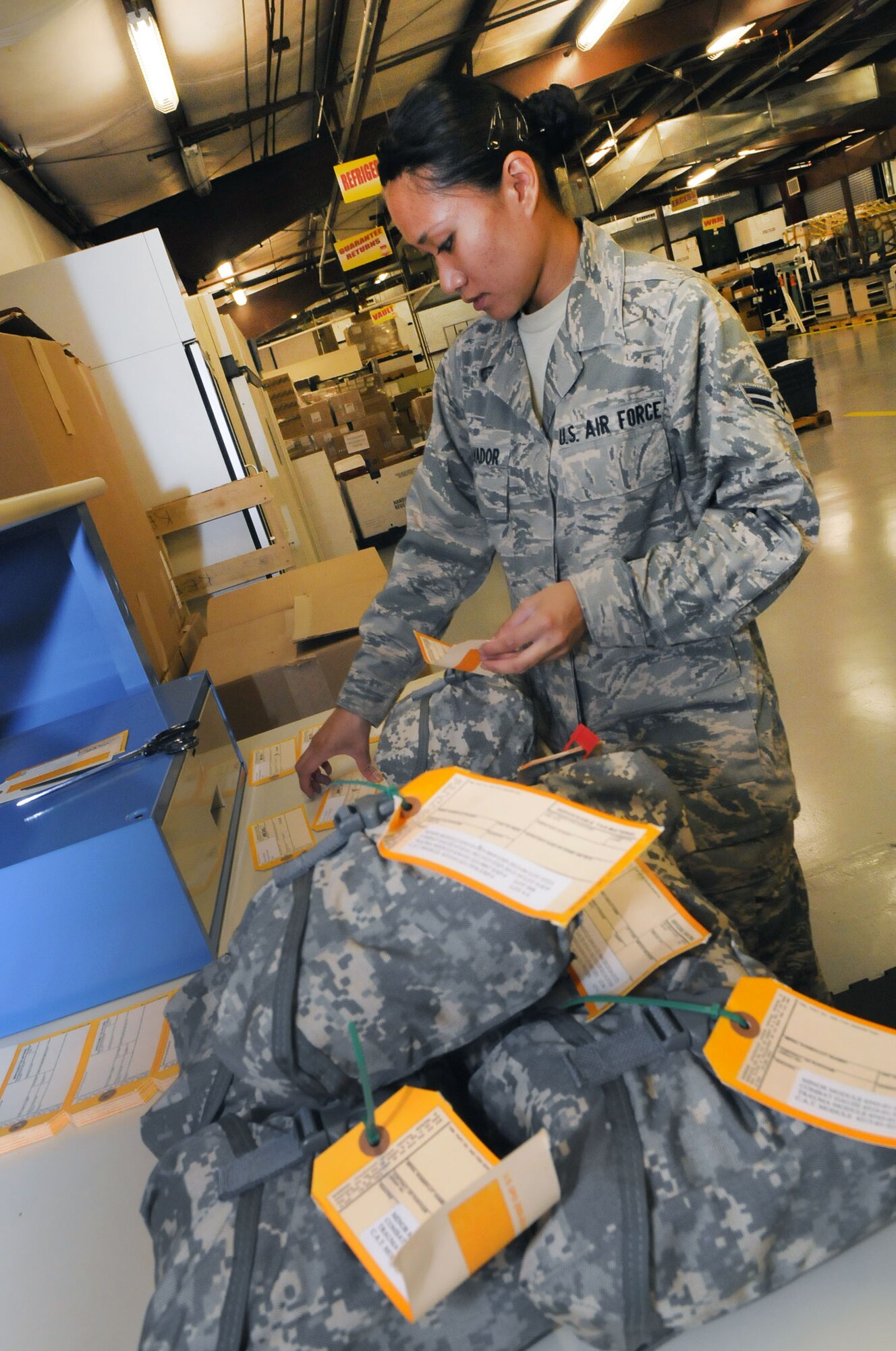 A1C Annzen Salvador, 78th Medical Logistics packs individual first aid kits for deployments. U. S. Air Force photo by Sue Sapp