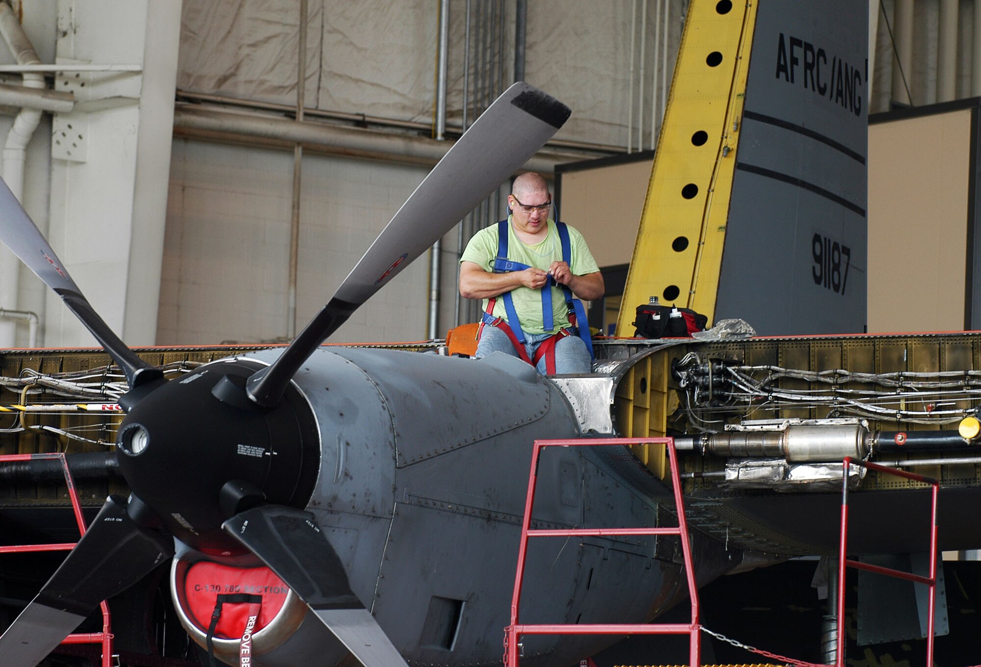 Quincy Smith wires a C-130 engine. The 402nd is still filling hundreds of openings for mechanics to meet the demands of getting planes back to the warfighter.  U. S. Air Force photo by Sue Sapp