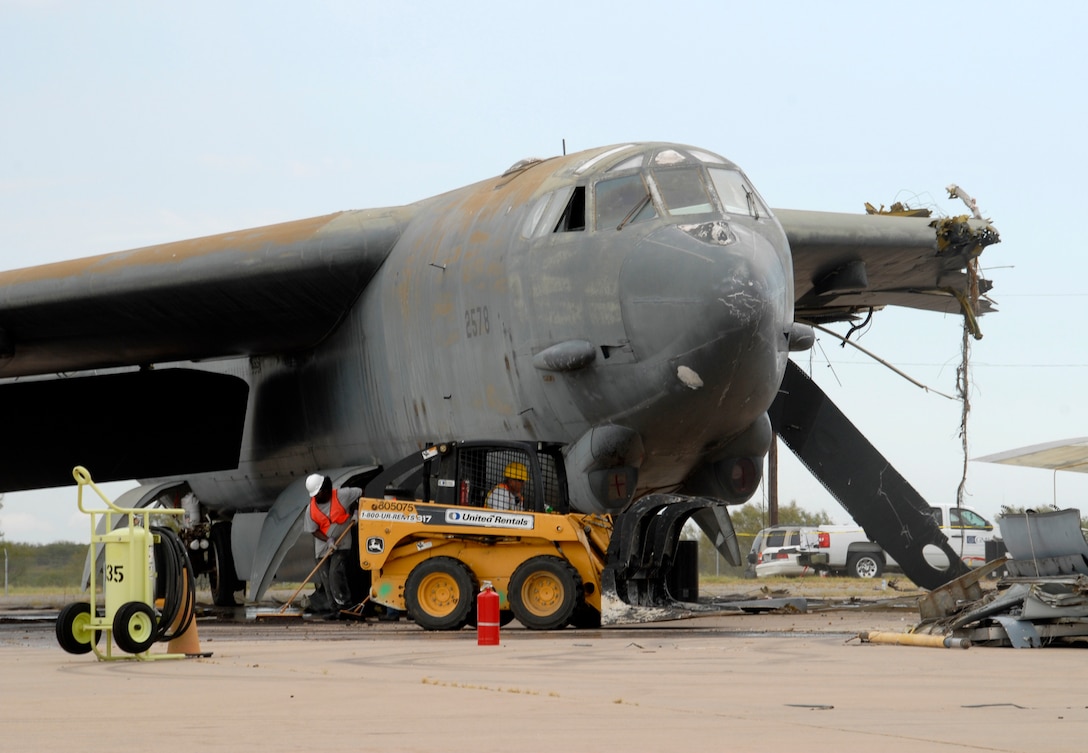 A contractor moves in to clear debris Aug. 24 during a process to demolish a B-52G Stratofortress. The 982nd Maintenance Squadron contacted Navy Facilities Engineering Command, Engineering Center at Port Hueneme, Calif., to have the aircraft dismantled at Sheppard. (U.S. Air Force photo/Mike Litteken)